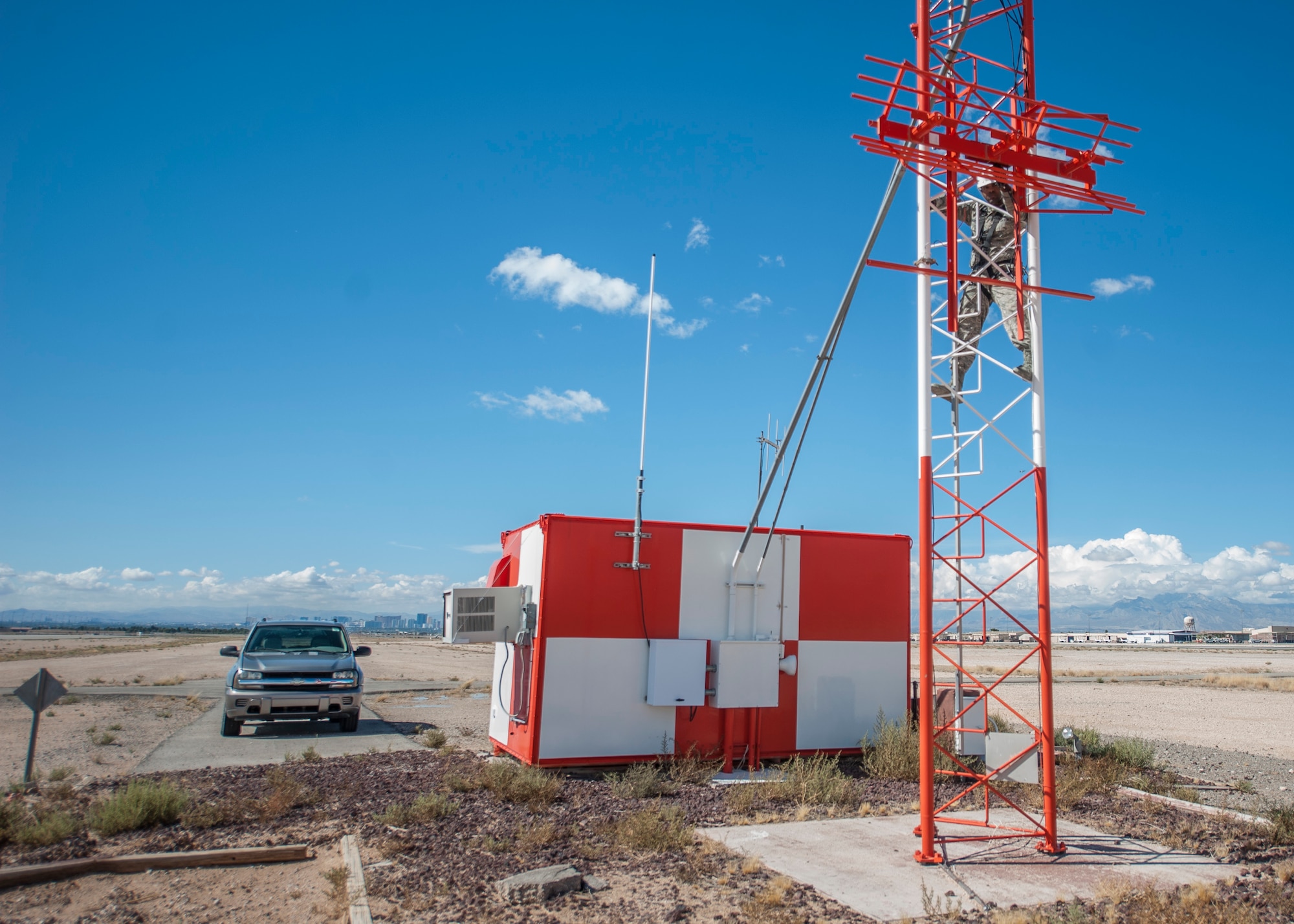 Senior Airman James Brown, 57th Operations Support Squadron airfield systems technician, inspects an instrument landing system on the airfield on Nellis Air Force Base, Nev., Oct. 6, 2015. Airfield systems specialists are charged with ensuring Airmen on the airfield and in the air traffic control tower always have a clear line of communication with local and transient pilots in the air. (U.S. Air Force photo by Staff Sgt. Siuta B. Ika)