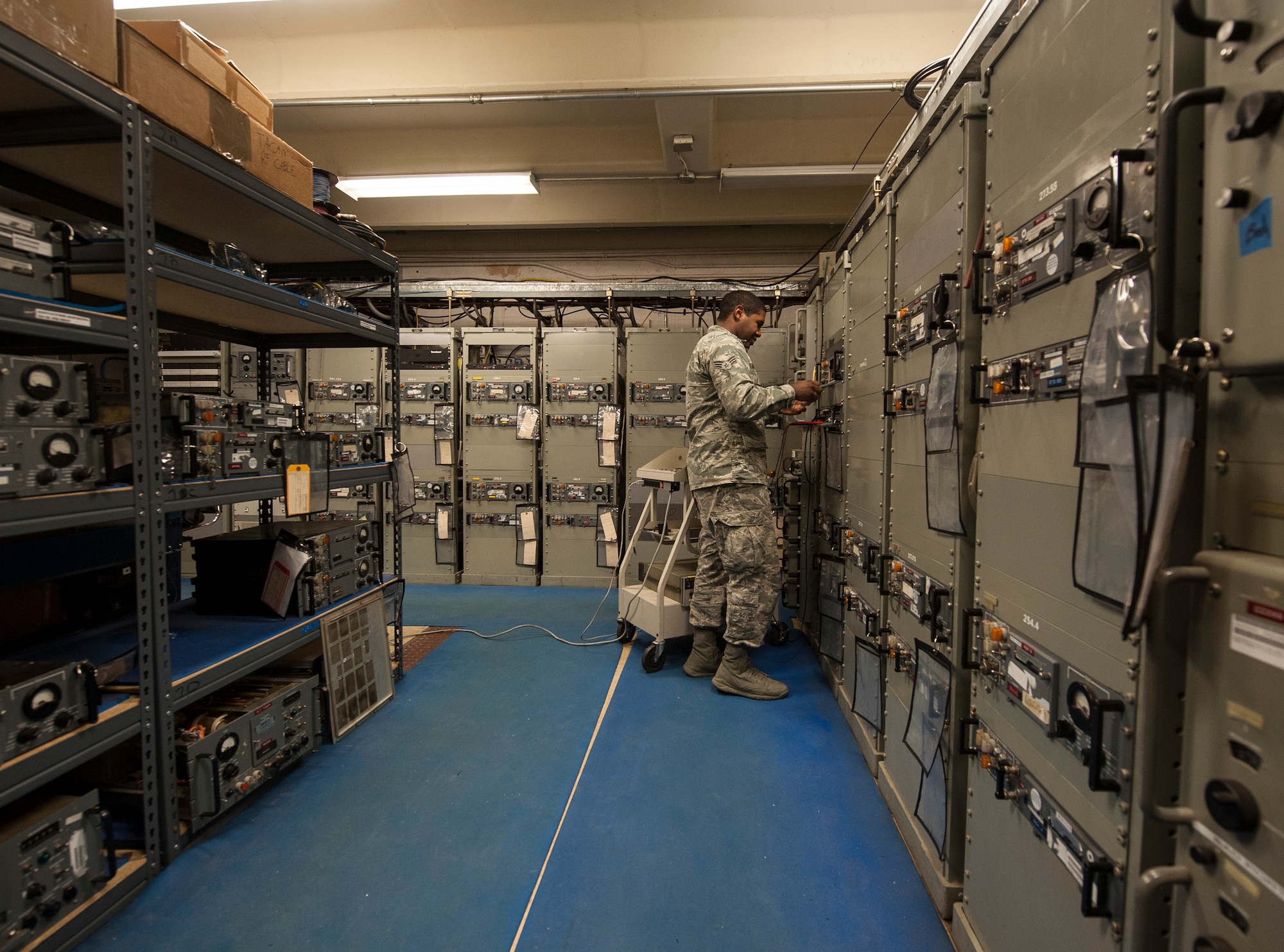 Senior Airman James Brown, 57th Operations Support Squadron airfield systems technician, checks the functionality of a transmitter and receiver at the Airfield Systems Maintenance compound on Nellis Air Force Base, Nev., Oct. 6, 2015. Airfield systems specialists work in airfield ground facilities as well as on equipment installed on aircraft. (U.S. Air Force photo by Staff Sgt. Siuta B. Ika)