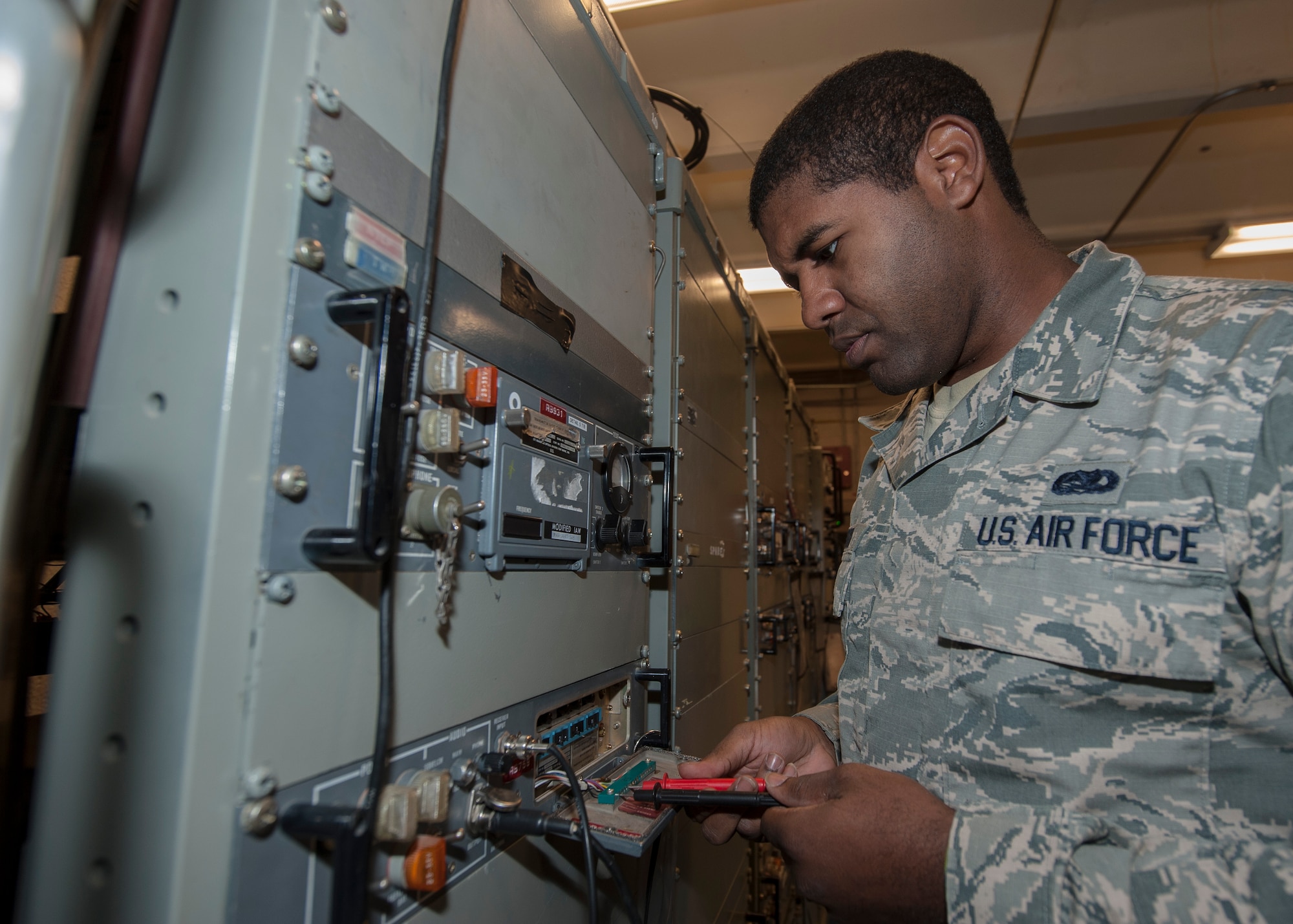 Senior Airman James Brown, 57th Operations Support Squadron airfield systems technician, checks the functionality of a receiver at the Airfield Systems Maintenance compound on Nellis Air Force Base, Nev., Oct. 6, 2015. The receiver, and its transmitter, enables air traffic controllers to maintain communication with pilots in the air. (U.S. Air Force photo by Staff Sgt. Siuta B. Ika)