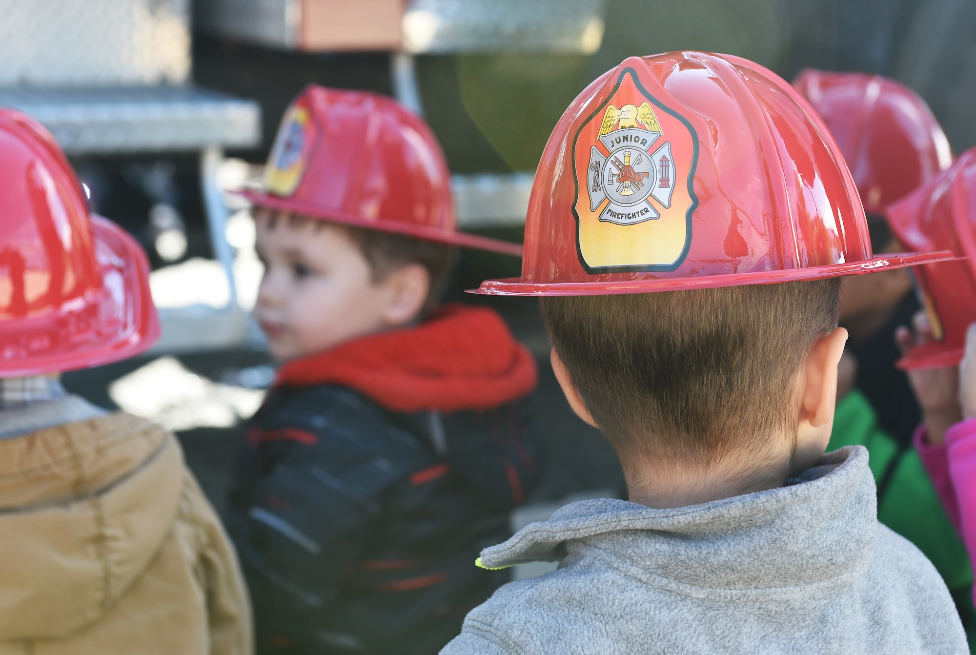 Children from the Crested Butte Child Development Center were given plastic fire helmets by the Buckley Fire Department Oct. 7, 2015, on Buckley Air Force Base, Colo. The fire department visited both CDCs on base to spread the word about Fire Prevention Week. For the visit, the children got to meet Sparky the Fire Dog, look at fire trucks, and take home coloring books. (U.S. Air Force photo by Airman 1st Class Samantha Meadors/Released)