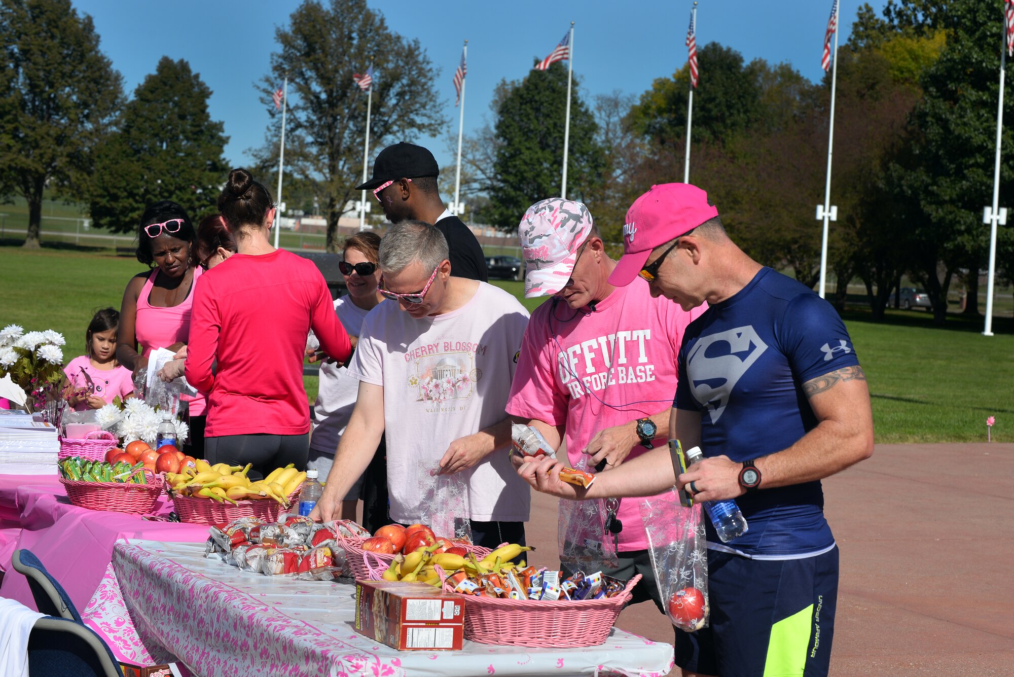 Breast Cancer Awareness 5K participants partake in a buffet of fruits and breast cancer awareness promotional material Oct. 2 on the historic parade grounds of Offutt Air Force Base, Neb.  The 5K was Offutt’s first breast cancer awareness run.  (U.S. Air Force photo by Josh Plueger/Released)