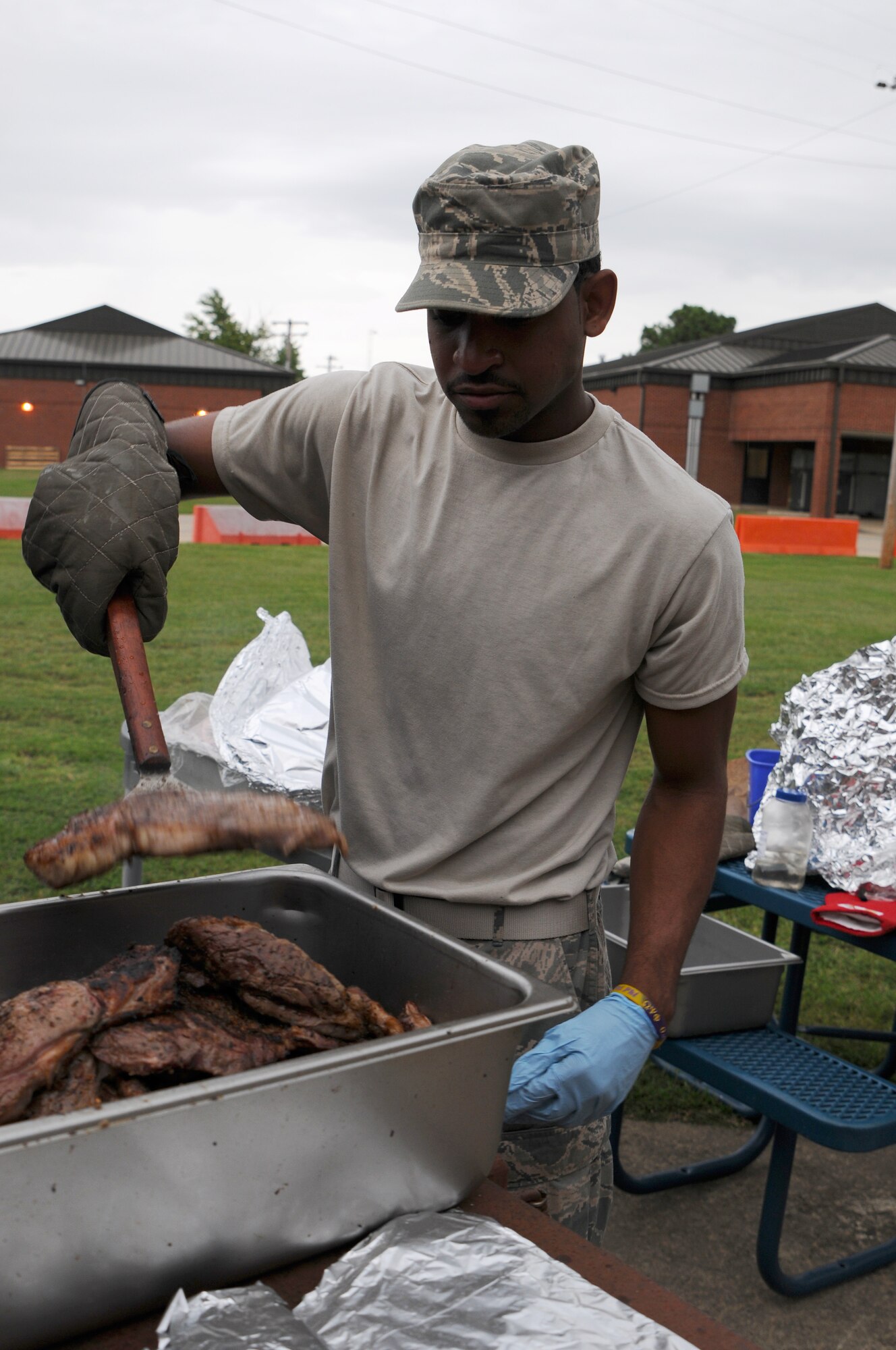 Senior Airman Antoine Leaks, 188th Force Support Squadron, prepares a surf and turf meal Sept. 20, 2015 by cooking steaks on a grill at Ebbing Air National Guard Base, Fort Smith, Ark. The 188th Wing’s surf and turf meal is an annual tradition provided at the end of the fiscal year. (U.S. Air National Guard photo by Senior Airman Cody Martin/Released)