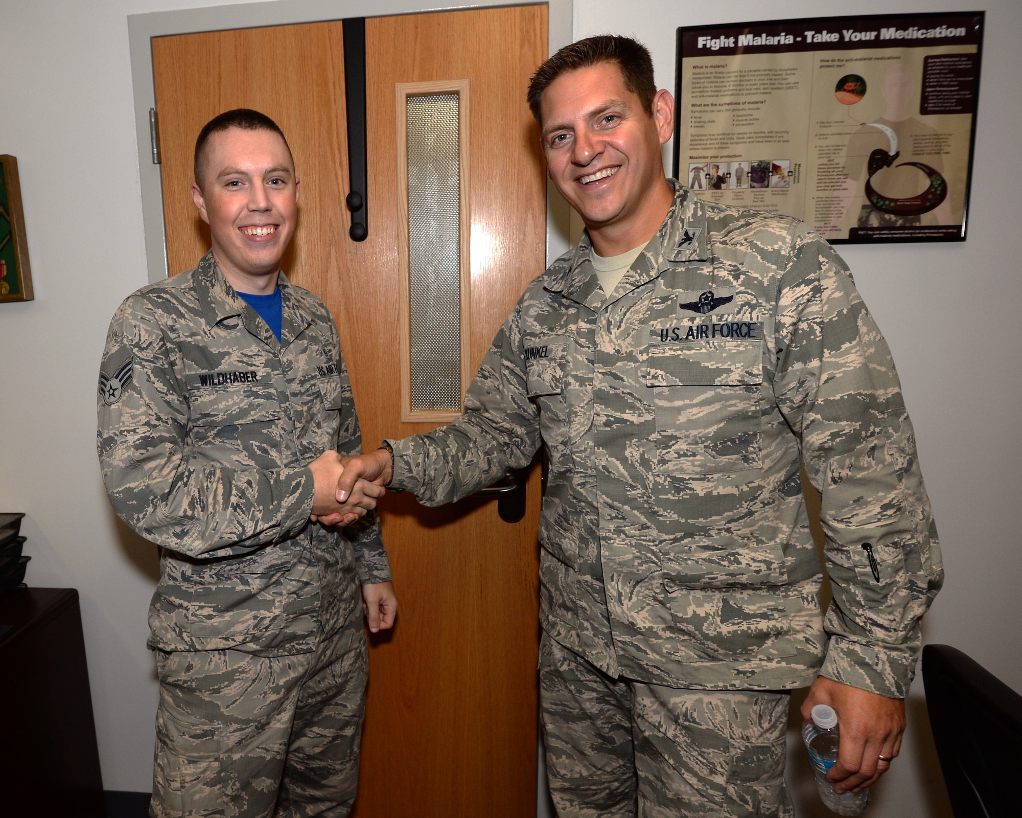 Senior Airman Larry D. Wildhaber, 325th Aerospace Medicine Squadron public health specialist and Col. Joseph D. Kunkel, 325th Fighter Wing vice commander, pose for a photo after a tour of the Public Health Flight of the 325th AMDS. Public health specialists like Wildhaber ensure the medical readiness of Airmen before they go down-range. (U.S. Air Force photo by Airman 1st Class Cody R. Miller/Released)