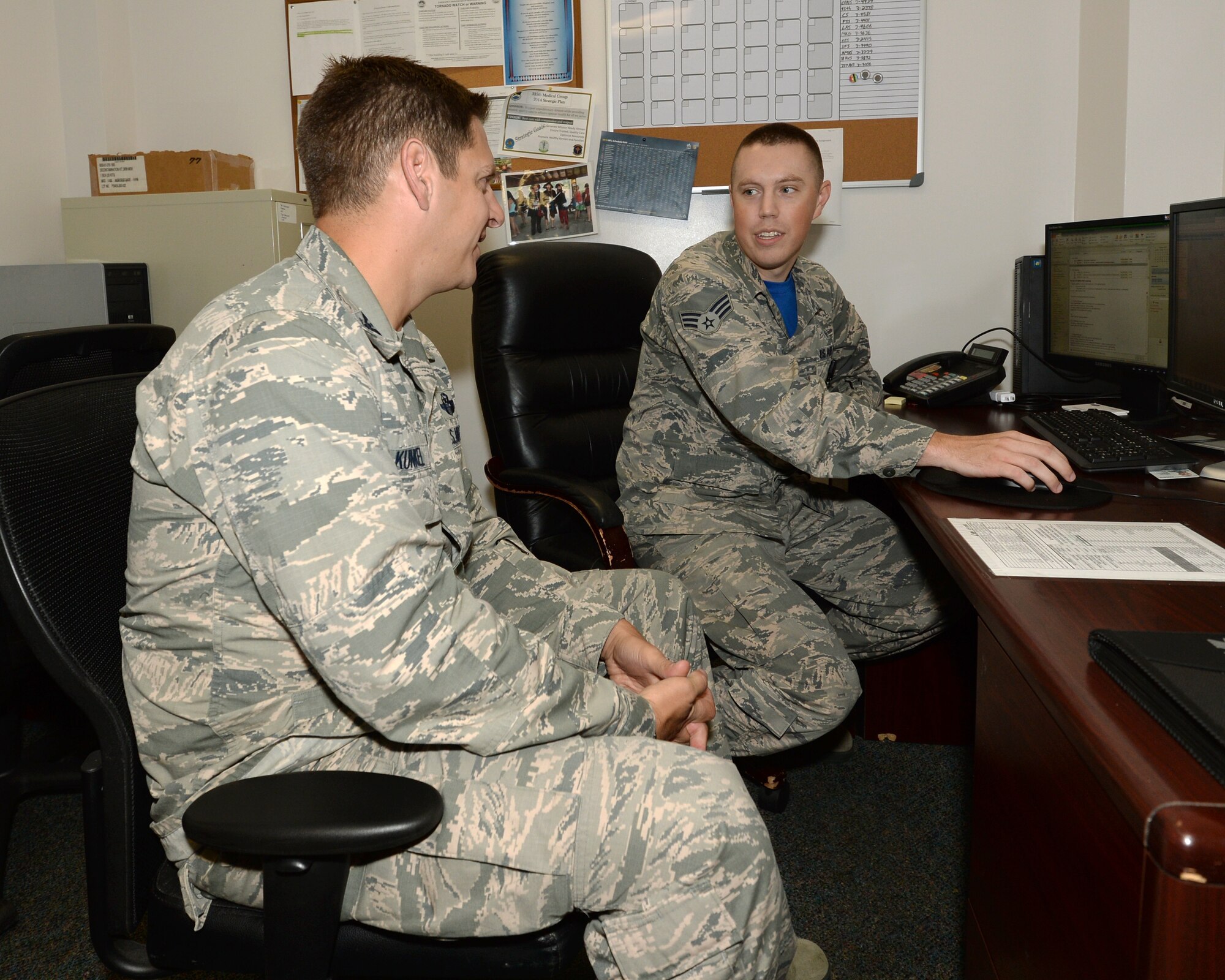 Senior Airman Larry D. Wildhaber, 325th Aerospace Medicine Squadron public health specialist, explains to Col. Joseph D. Kunkel, 325th Fighter Wing vice commander, the process to medically clear Airmen for deployments. Every Airman that deploys from Tyndall must go through a series of medical evaluations to ensure they are physically and mentally ready to endure the stresses of a deployed environment. (U.S. Air Force photo by Airman 1st Class Cody R. Miller/Released)