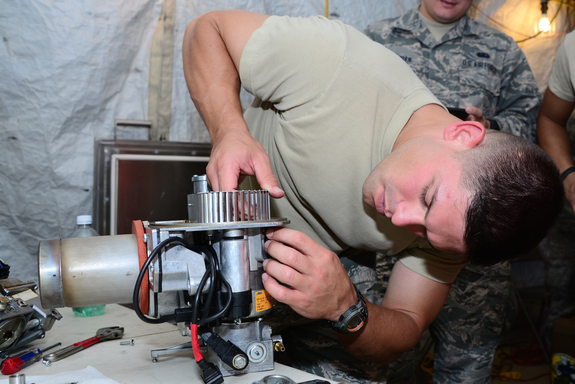 U.S. Air Force Airman 1st Class Austin Harder, 56th Force Support Squadron food service specialist, reassembles a Babington Airtronic burner during an expeditionary kitchen training at Davis-Monthan Air Force Base, Ariz., Sept. 29, 2015. Harder, among other FSS Airmen, learned how to operate, repair, and maintain the burner during the training. (U.S. Air Force photo by Airman 1st Class Mya M. Crosby/Released)