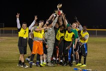 The 790th Missile Security Forces Squadron’s intermural flag football team celebrates their victory over the Tactical Response Force team Oct. 5, 2015 on a softball field near the Freedom Hall Fitness Center, F.E. Warren Air Force Base, Wyo. The 790th team won by a single point, scored with just minutes left in the game. (U.S. Air Force photo by Lan Kim)