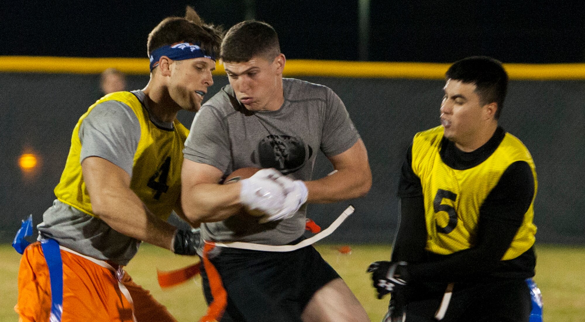 Nicholas Howard, Tactical Response Force, attempts to spin away from two 790th Missile Security Forces Squadron defenders Oct. 5, 2015, during the 90th Missile Wing intermural flag football championship on F.E. Warren Air Force Base, Wyo.  TRF was the defending champions, but lost in the last minutes of the game. (U.S. Air Force photo by Lan Kim)