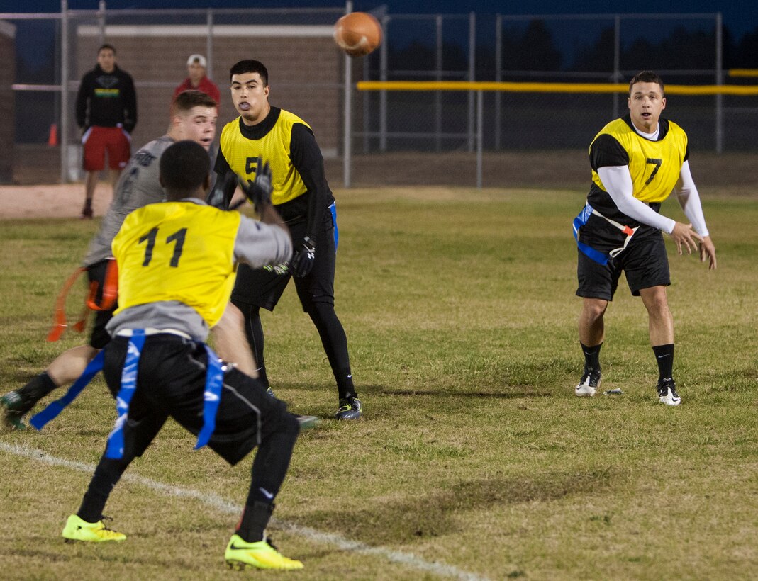 Raymond Taboada, 790th Missile Security Forces Squadron, passes to teammate Torrell Grier Oct. 5, 2015, during the 90th Missile Wing intermural flag football championship game on F.E. Warren Air Force Base, Wyo. The 790th needed to take back-to-back wins to walk away as the new champions in the double elimination tournament. (U.S. Air Force photo by Lan Kim)