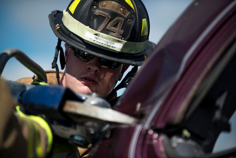 Senior Airman Travis Manchester, 11th Wing Civil Engineer firefighter, uses the jaws of life during an automobile extraction exercise at Joint Base Andrews, Md., Oct. 7, 2015. The exercise was part of the fire prevention week on JBA. (U.S Air Force photo by Airman 1st Class Philip Bryant/Released)