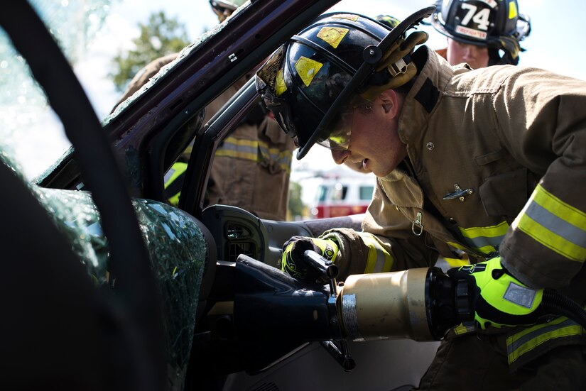 Senior Airman Justin Bierwirth, 11th Wing Civil Engineer firefighter, uses the jaws of life during an automobile extraction exercise at Joint Base Andrews, Md., Oct. 7, 2015. The exercise was part of the fire prevention week on JBA. (U.S Air Force photo by Airman 1st Class Philip Bryant/Released)
