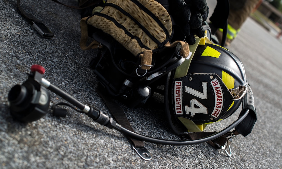 An 11th Wing Civil Engineer fire helmet sits on the ground at Joint Base Andrews, Md., during a live fire exercise Oct. 7, 2015. The exercise was part of the fire prevention week on JBA. (U.S Air Force photo by Airman 1st Class Philip Bryant/Released)