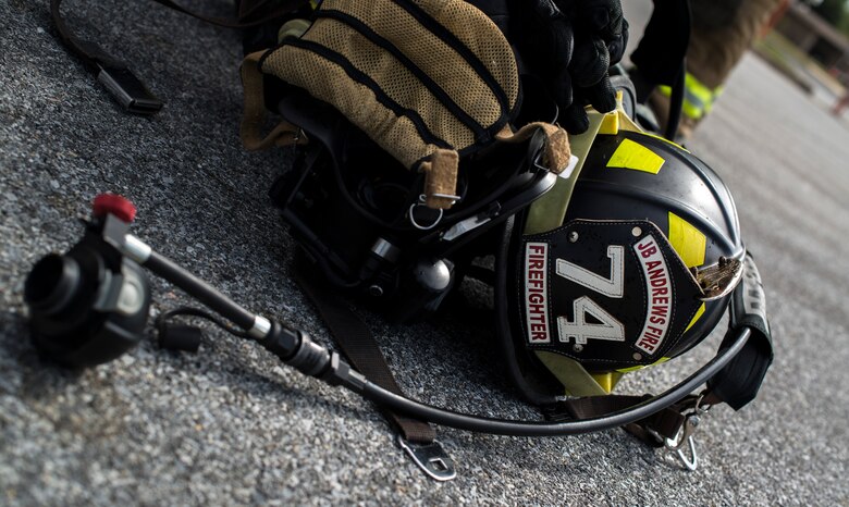 An 11th Wing Civil Engineer fire helmet sits on the ground at Joint Base Andrews, Md., during a live fire exercise Oct. 7, 2015. The exercise was part of the fire prevention week on JBA. (U.S Air Force photo by Airman 1st Class Philip Bryant/Released)