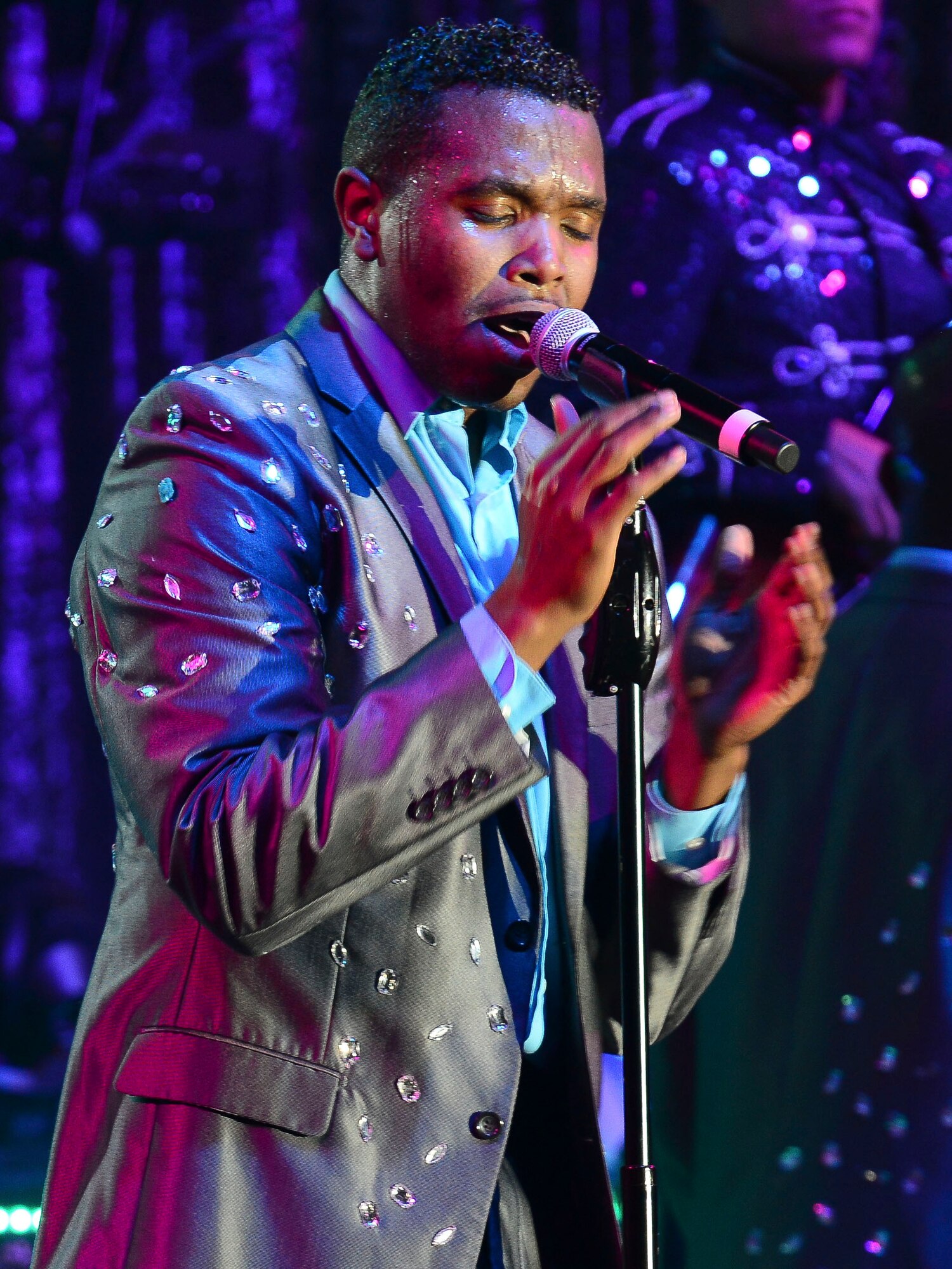 U.S. Air Force Senior Airman Jordan Whitehead, Tops in Blue vocalist, performs a song during at show at the Hampton Roads Convention Center in Hampton, Va., Oct. 6, 2015. Tops in Blue serves as an expeditionary entertainment unit to provide entertainment to Airmen and the general public. (U.S. Air Force photo by Staff Sgt. Ciara Gosier/Released)