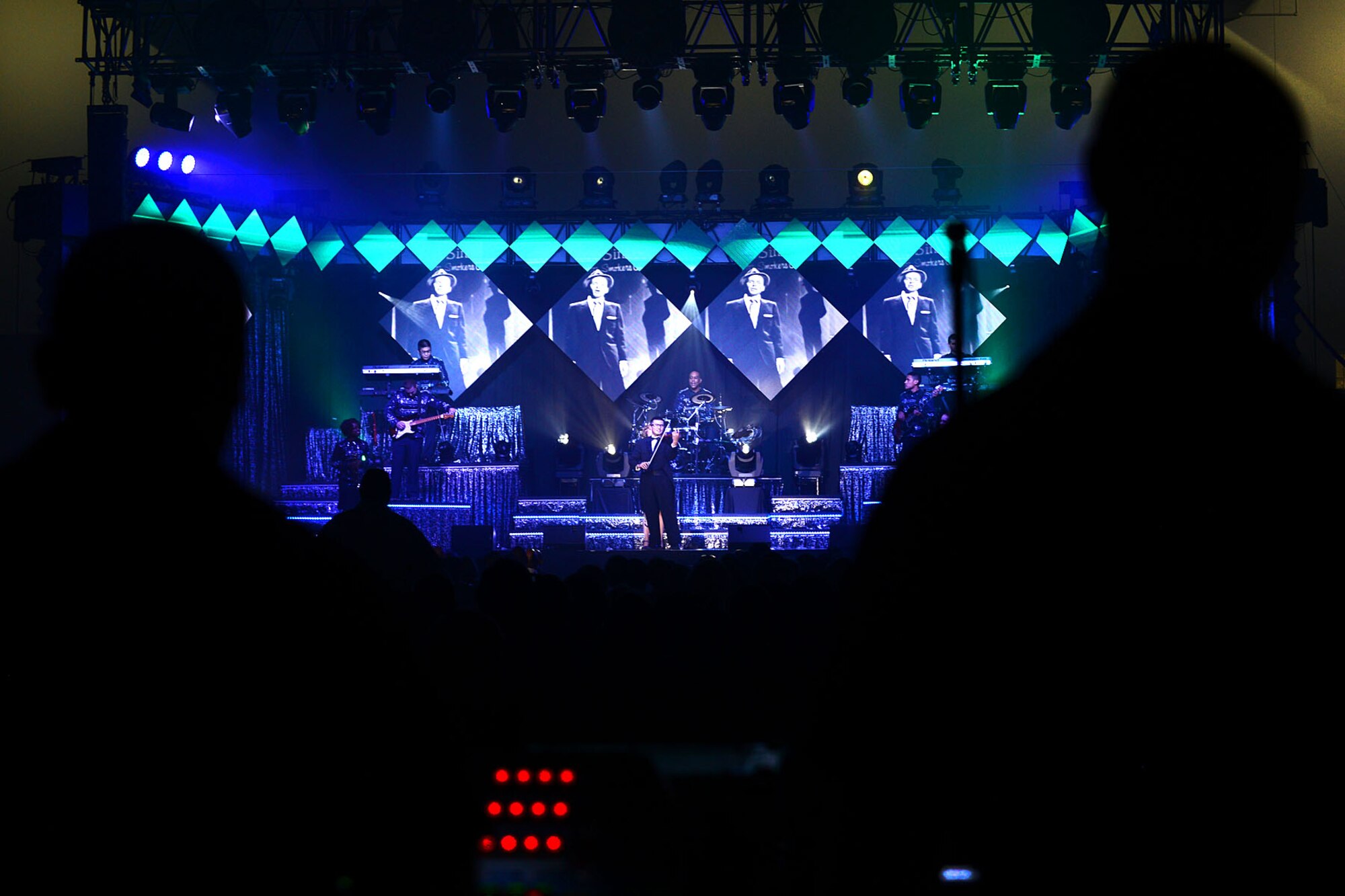 U.S. Air Force 1st Lt. Oliver Chang, Tops in Blue violinist, performs a solo during a show at the Hampton Roads Convention Center in Hampton, Va., Oct. 6, 2015. Members of Tops in Blue tour with the intent of entertaining military personnel and their families around the world. (U.S. Air Force photo by Senior Airman Kimberly Nagle/Released)