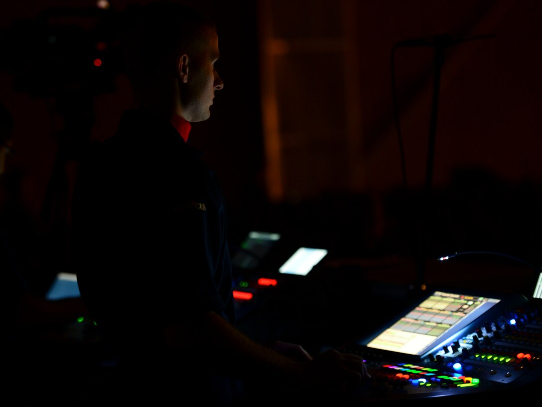 U.S. Air Force Senior Airman Ethan Helgager, Tops in Blue technician, controls lighting and sounds during a show at the Hampton Roads Convention Center in Hampton, Va., Oct. 6, 2015. In addition to operating their own technical equipment, Tops in Blue personnel are also responsible for transporting, loading, unloading and setting up over 65,000 pounds of equipment required for each show. (U.S. Air Force photo by Staff Sgt. Ciara Gosier/Released)