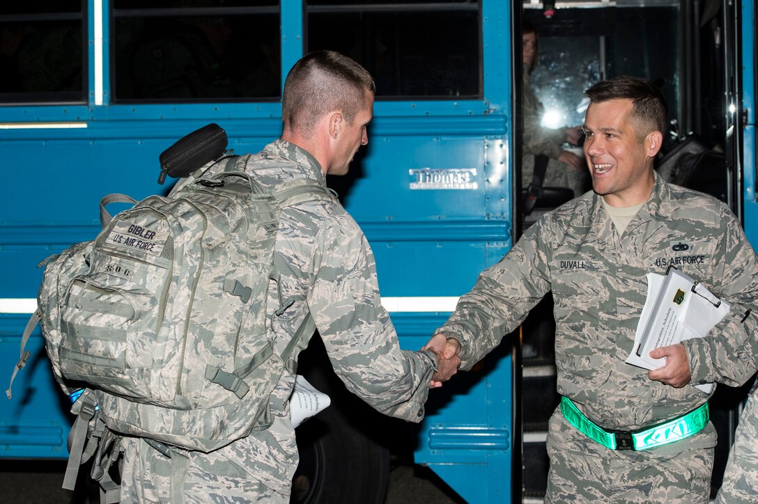 U.S. Air Force Tech. Sgt. Matthew Duvall, 1st Maintenance Squadron unit deployment manager, greets an Airman returning from a deployment at Langley Air Force Base, Va., Oct. 5, 2015. The 94th and 149th Fighter Squadrons deployed in support of Operation Inherent Resolve. (U.S. Air Force photo by Senior Airman Kayla Newman/Released)