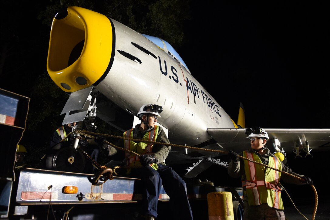 Senior Airmen Joshua Rule (left) and Aubrey Berger, 4th Equipment Maintenance Squadron crew chiefs, affix a taught line to an F-86H Sabre on Oct. 6, 2015, at Seymour Johnson Air Force Base, North Carolina. Airmen from the 4th EMS restored the aircraft, on loan from the city of Goldsboro, North Carolina. (U.S. Air Force photo/Senior Airman Aaron J. Jenne)