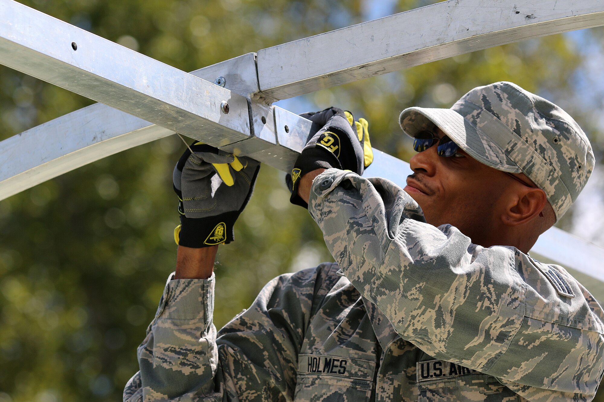 WRIGHT-PATTERSON AIR FORCE BASE, Ohio – Senior Airman Elliott Holmes, 445th Civil Engineer Squadron, works to erect an Alaskan tent during a bivouac training exercise at the Warfighter Training Center Sept. 13, 2015. The Alaskan is one of many types of tents used on deployments. U.S. Air Force photo /Tech. Sgt. Patrick O’Reilly)