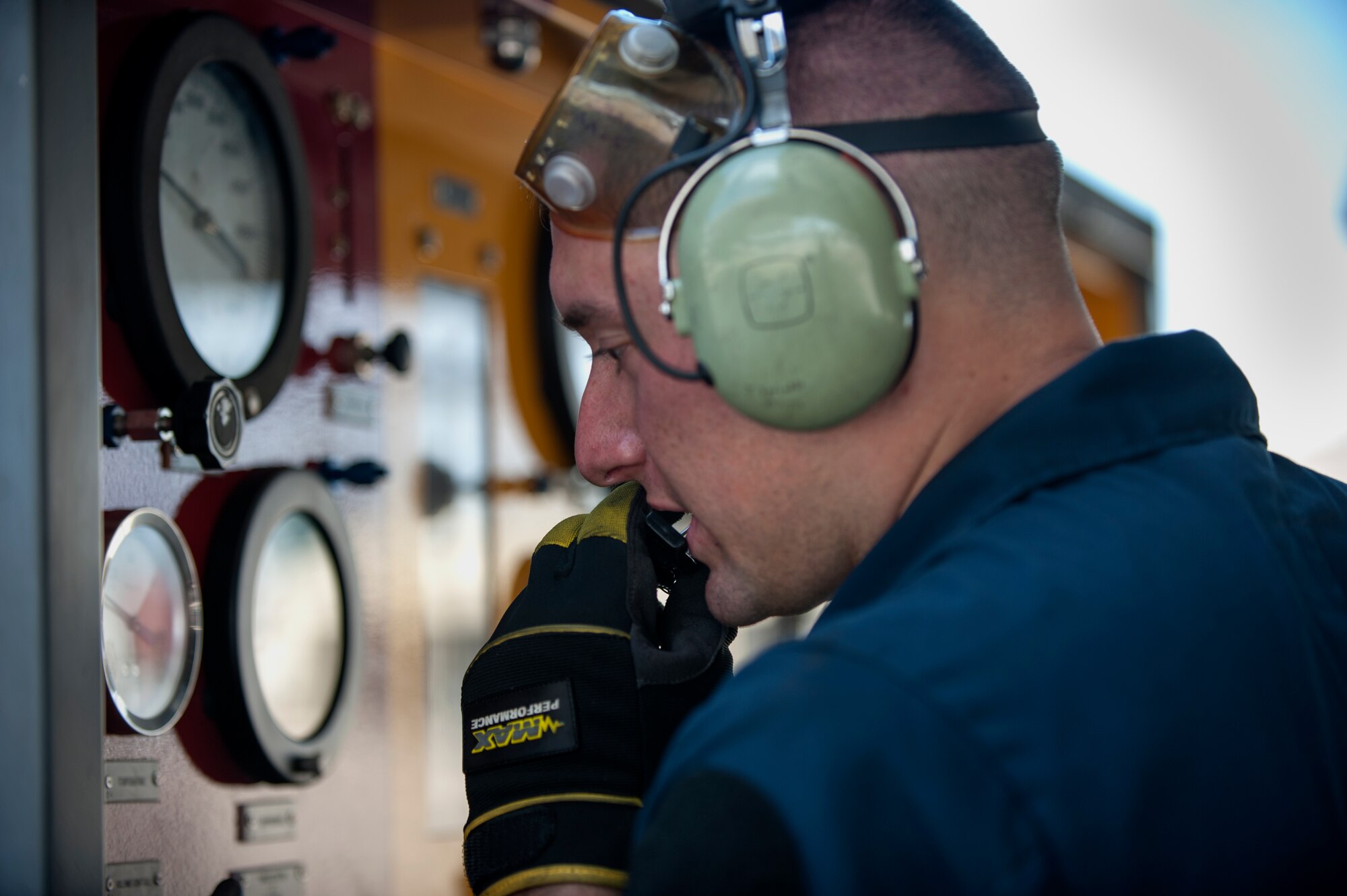 Airman 1st Class Joshua Sprinkle, 4th Aircraft Maintenance Squadron crew chief, talks to another crew chief while monitoring gauges on a piece of aerospace ground equipment as part of a 9th Air Force aircraft generation exercise, Sept. 10, 2015, at Seymour Johnson Air Force Base, North Carolina. Generation exercises allow the wing to identify issues or stress points before being tasked with a real world mission. (U.S. Air Force photo/Airman Shawna L. Keyes)