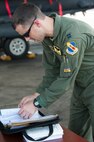 Capt. Bill Slater, 336th Fighter Squadron pilot, checks a maintenance log for an F-15E Strike Eagle as part of a 9th Air Force aircraft generation exercise, Sept. 10, 2015, at Seymour Johnson Air Force Base, North Carolina. Maintenance and aircrew professionals performed a “cold check" on a dozen aircraft to ensure they were ready for launch the following day. (U.S. Air Force photo/Airman Shawna L. Keyes)