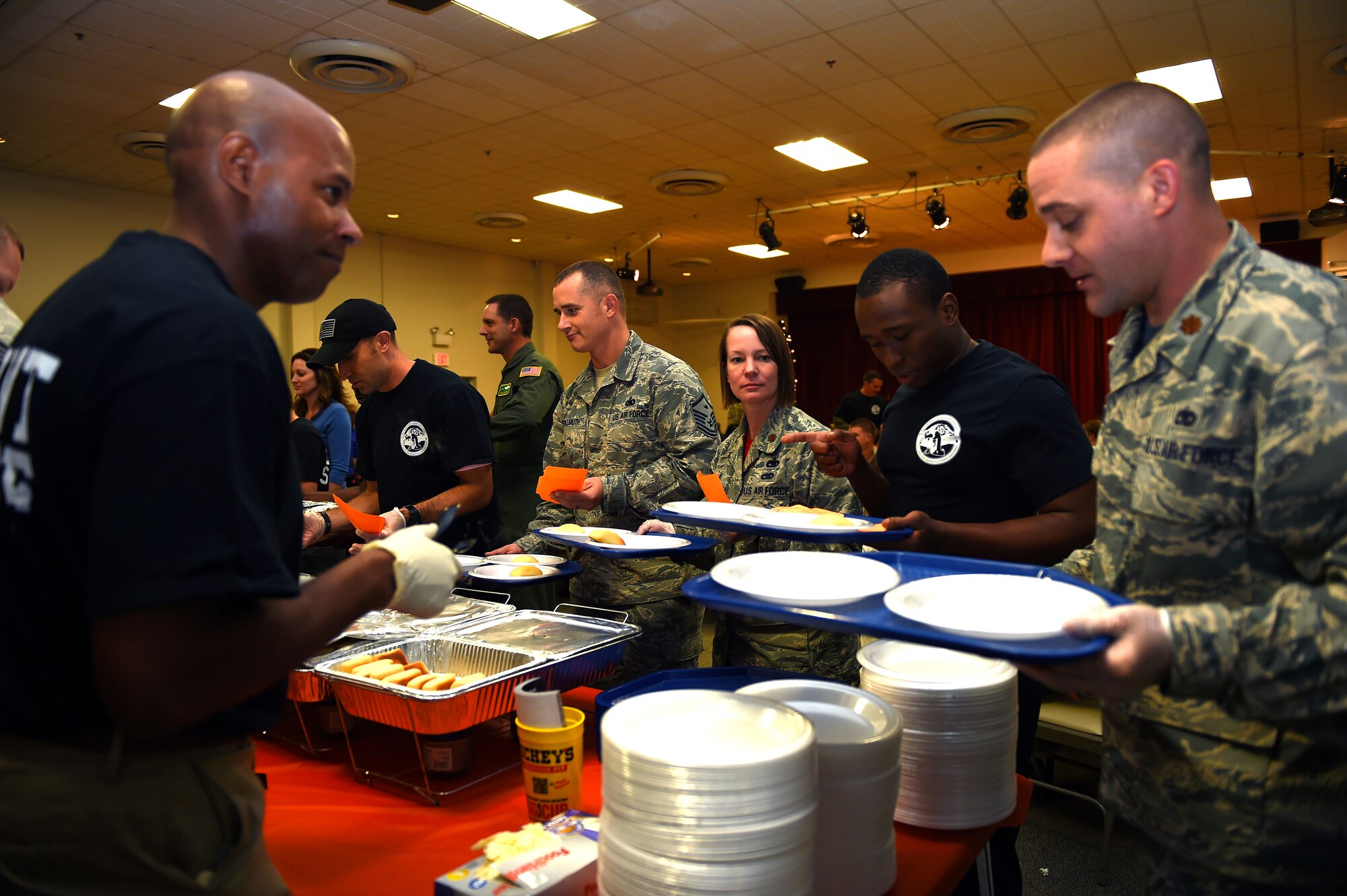 Leadership from Team McChord fill orders during the deployed family dinner at the Chapel Support Center on Joint Base Lewis-McChord, Wash., Oct. 2, 2015. Nearly 90 volunteers supported the three hour event. (U.S. Air Force photos/Senior Airman Naomi Griego)