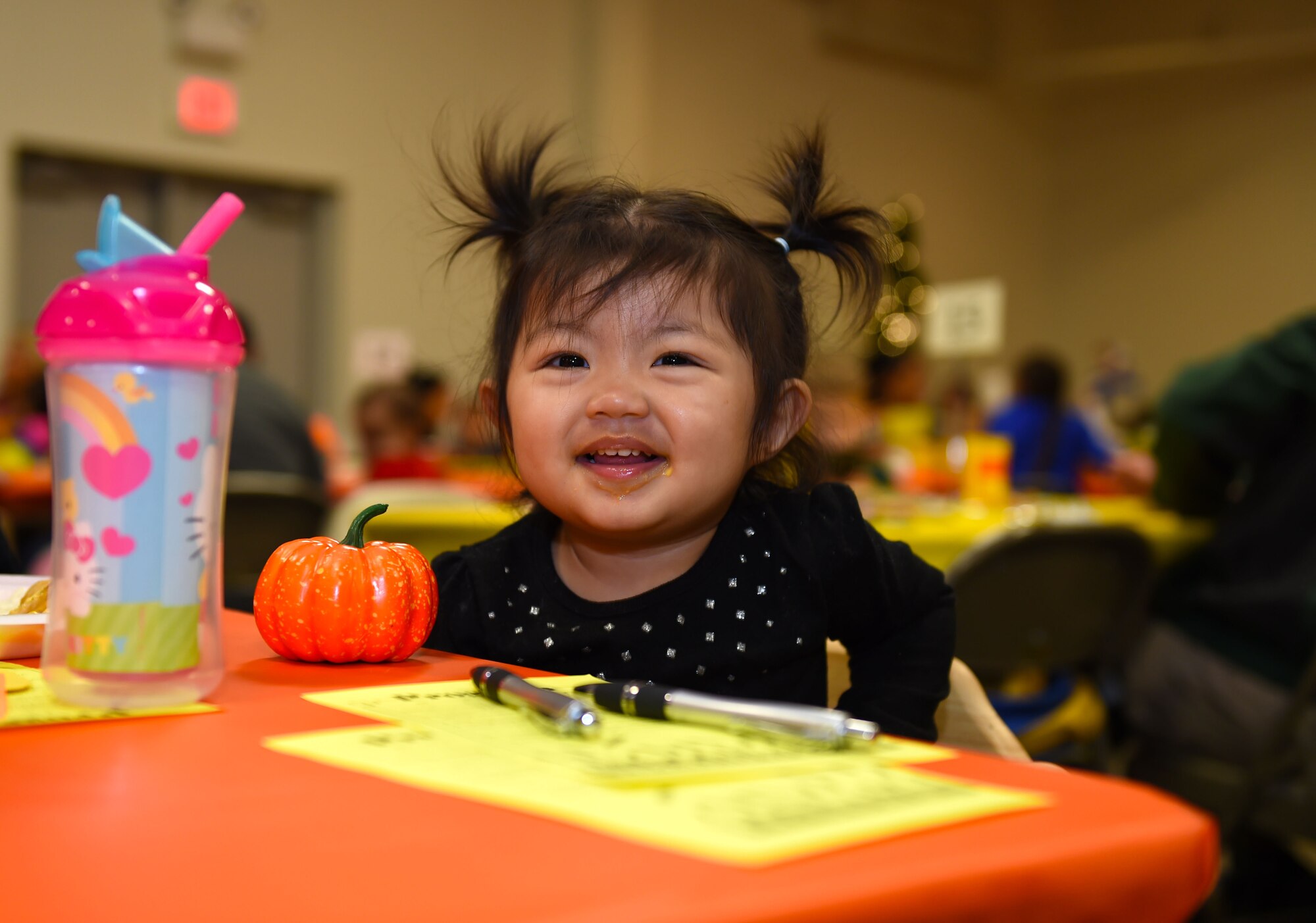A young girl of a deployed McChord member, sits at a table during the deployed family dinner at the Chapel Support Center on Joint Base Lewis-McChord, Wash., Oct. 2, 2015. This annual event is a chance for family members of deployed Airmen to socialize with one another while at the same time being recognized by leadership.(U.S. Air Force photos/Senior Airman Naomi Griego) 