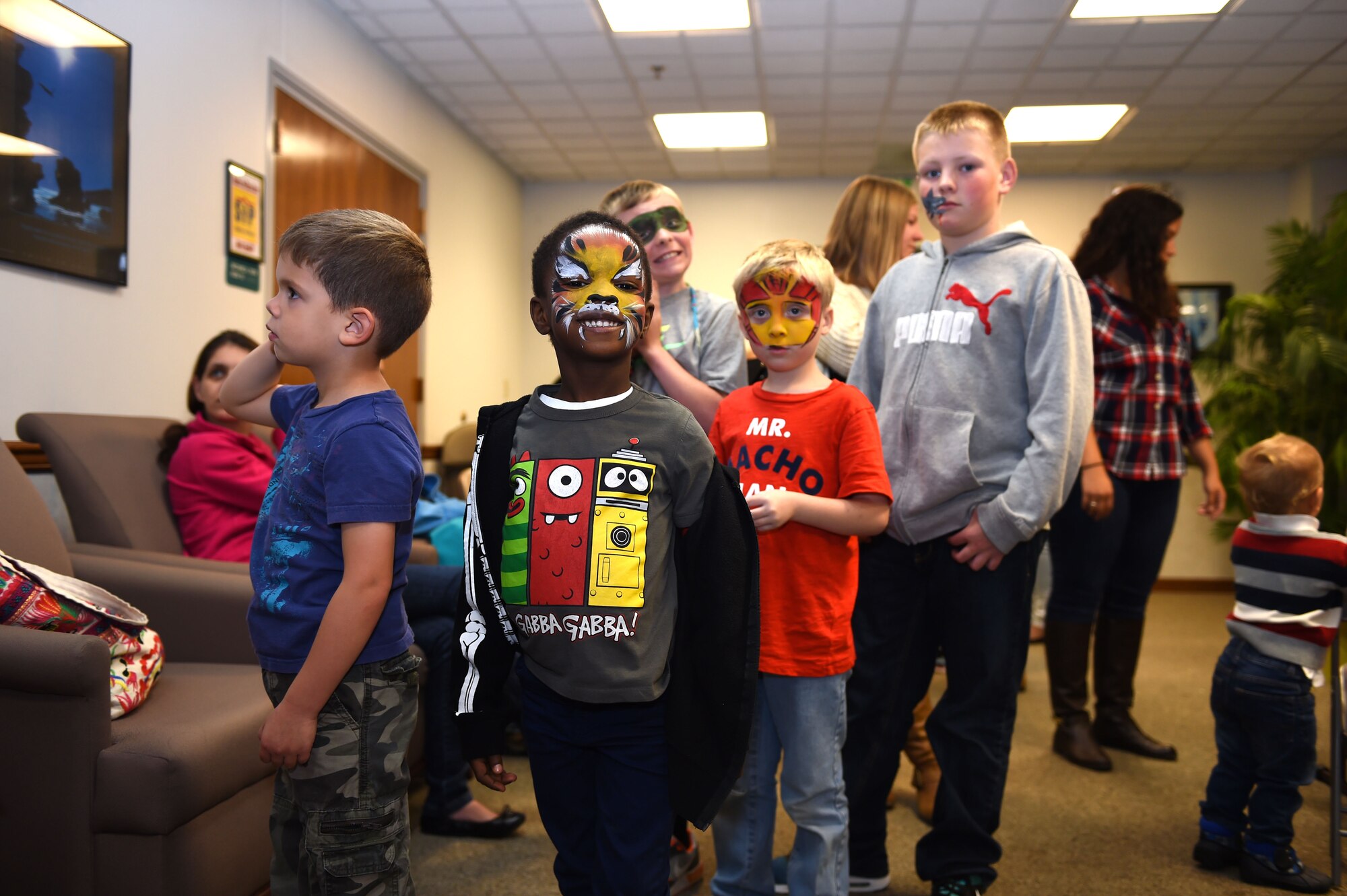 Children stand in the balloon animal line during the deployed family dinner at the Chapel Support Center on Joint Base Lewis-McChord, Wash., Oct. 2, 2015. There were activities which included face painting, arts and crafts, a petting zoo, and a bouncy castle were geared towards children of all ages. (U.S. Air Force photos/Senior Airman Naomi Griego) 