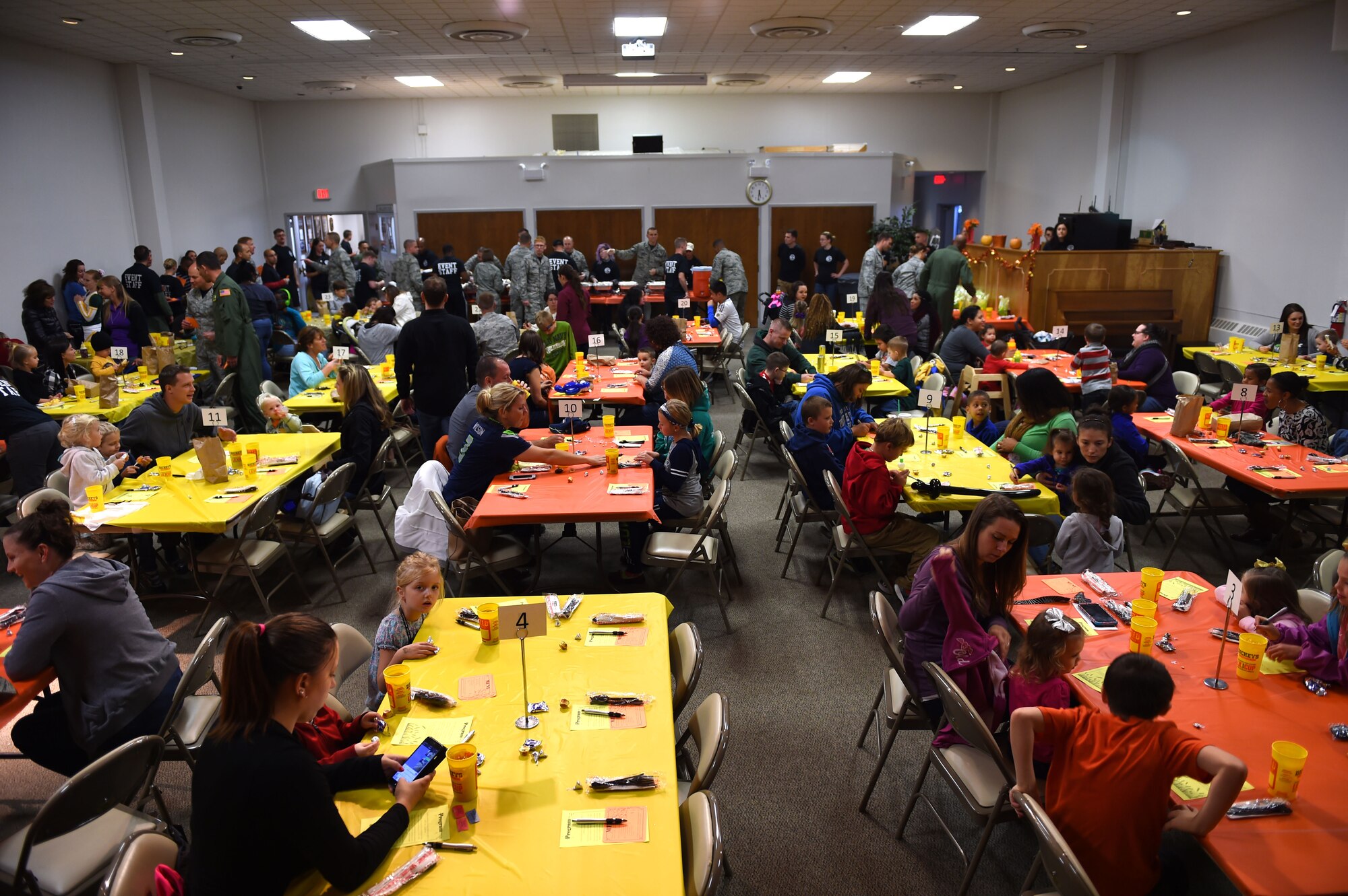 Families sit and wait to be served food during the deployed family dinner at the Chapel Support Center on Joint Base Lewis-McChord, Wash., Oct. 2, 2015. McChord leadership and volunteers supported the Chapel event by serving food, supervising the arts and crafts center and assisting families. (U.S. Air Force photos/Senior Airman Naomi Griego) 