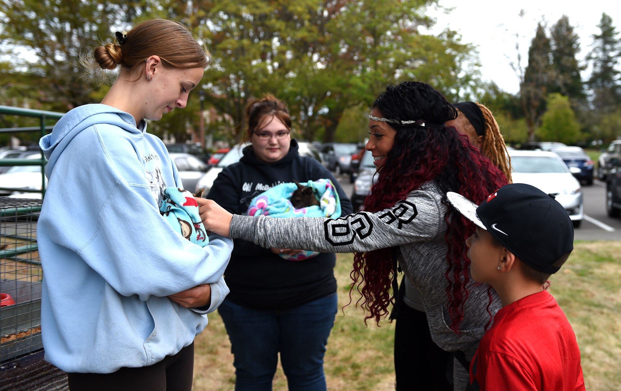 A family attending the deployed family dinner pets a rabbit outside the Chapel Support Center on Joint Base Lewis-McChord, Wash., Oct. 2, 2015. Families who attended the free event enjoyed a catered dinner, a petting zoo, face painting, a bouncy castle and arts and crafts activities for children. (U.S. Air Force photo/Senior Airman Naomi Griego)