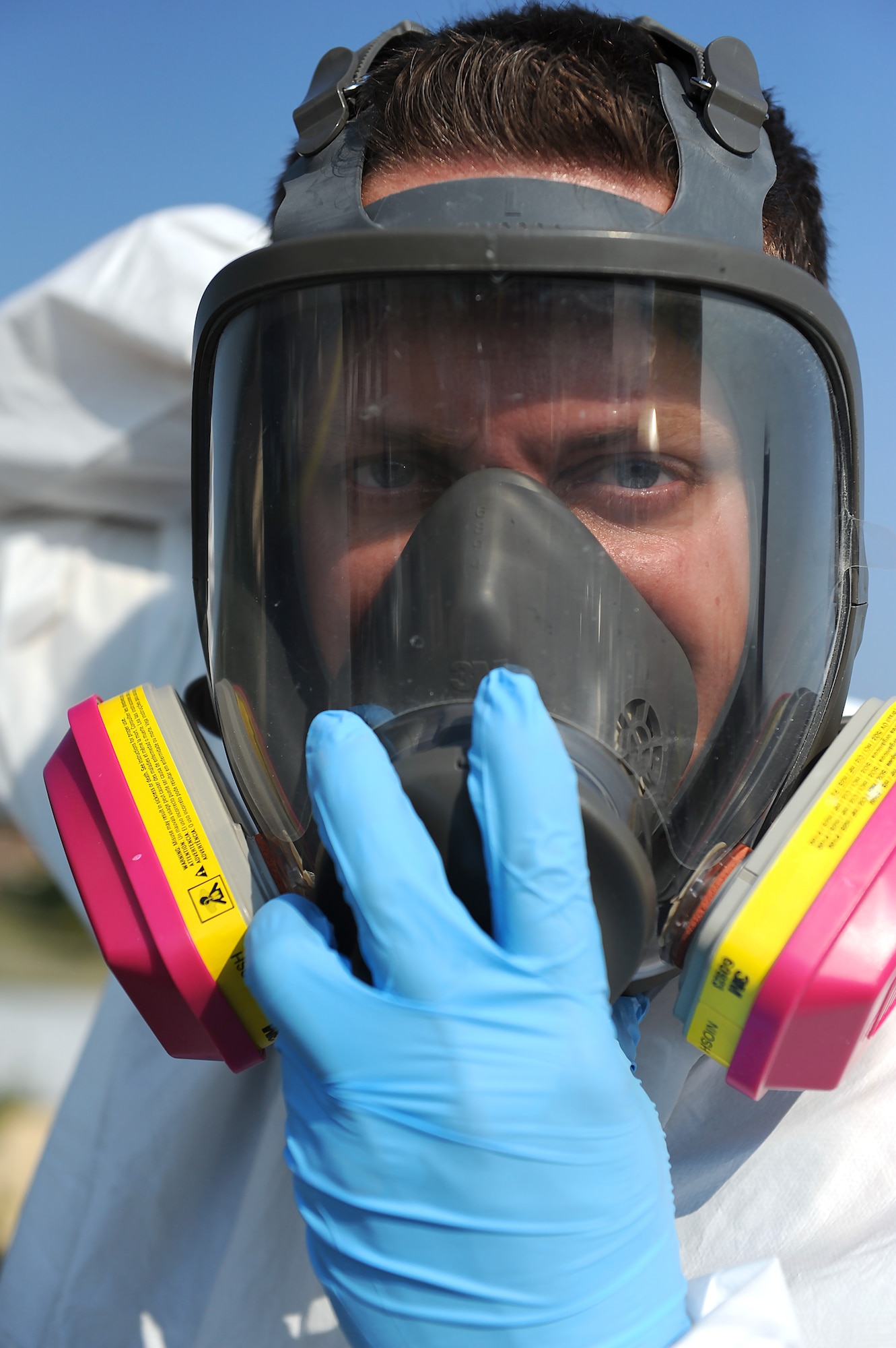Tech. Sgt. Nicholas Fonzo, 509th Maintenance Squadron low observable technician, dons his respirator mask prior to performing maintenance on a Minuteman II Missile static display Sept. 1, 2015, at Whiteman Air Force Base, Mo. In addition to aircraft painting and other normal duties, low observable technicians perform cosmetic maintenance on static displays at Whiteman. (U.S. Air Force photo by Airman 1st Class Michaela R. Slanchik/Released)
