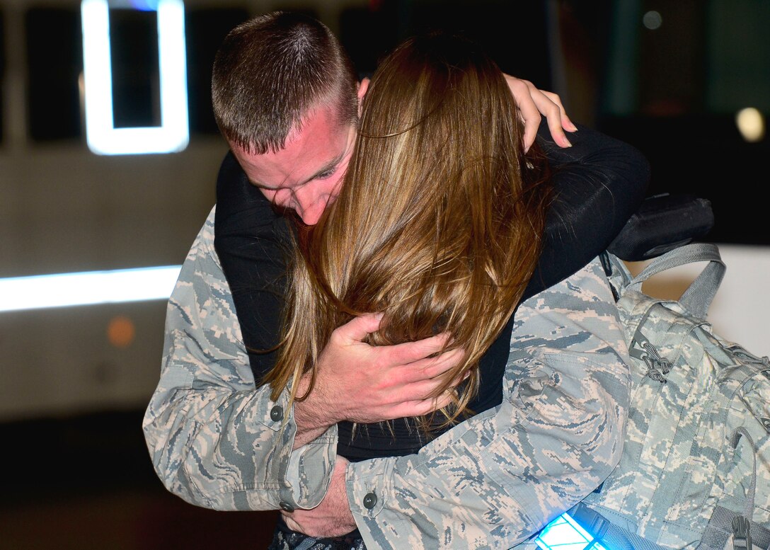 A U.S Air Force Airman is greeted with a hug from a family member upon returning from a six-month deployment at Langley Air Force Base, Va., Oct. 5, 2015. The 1st and 192nd Fighter Wings were assigned to United States Central Command as a part of a theater security package. (U.S. Air Force photo by Airman 1st Class Derek Seifert/ Released)