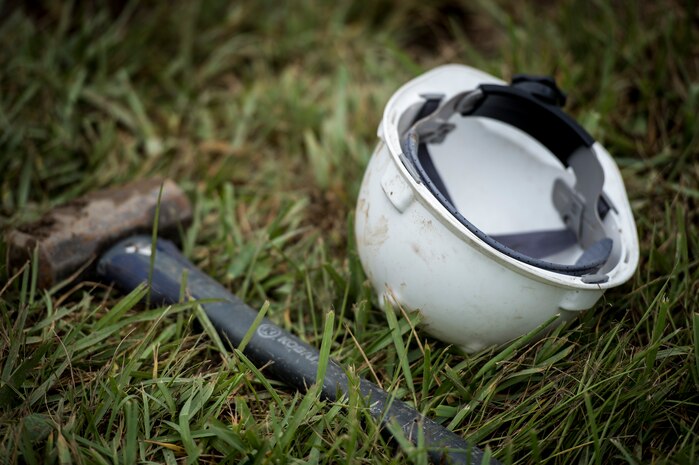 A hammer and helmet lay on the ground next to a work site Oct. 6, 2015, on a road on Joint Base Charleston – Weapons Station, S.C. While hurricane Joaquin did not make landfall on the east coast, a constant flow of heavy rain caused flooding throughout the Carolinas. The 628th CES quickly accessed the damage and took action to fix and restore base assets. (U.S. Air Force photo/Airman 1st Class Clayton Cupit)