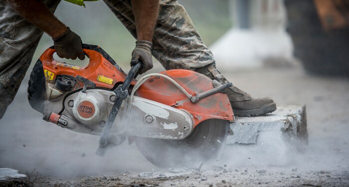 Staff Sgt. Devin Kennedy, 628th Civil Engineer Squadron heavy equipment operator, operates a cut-off machine Oct. 6, 2015, on a road on Joint Base Charleston – Weapons Station, S.C. While hurricane Joaquin did not make landfall on the east coast, a constant flow of heavy rain caused flooding throughout the Carolinas. The 628th CES quickly accessed the damage and took action to fix and restore base assets. (U.S. Air Force photo/Airman 1st Class Clayton Cupit)