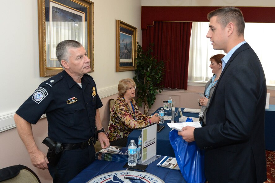 Chief Brian Levitre, U.S. Customs and Border Protection recruiter, speaks with Michael Grady during a Hanscom Career Fair at the Minuteman Commons Oct. 7. The Hanscom Airman and Family Readiness Center partnered with the U.S. Army Natick Soldier Systems Center and the Boston Celtics to host the event. (U.S. Air Force photo by Jerry Saslav)