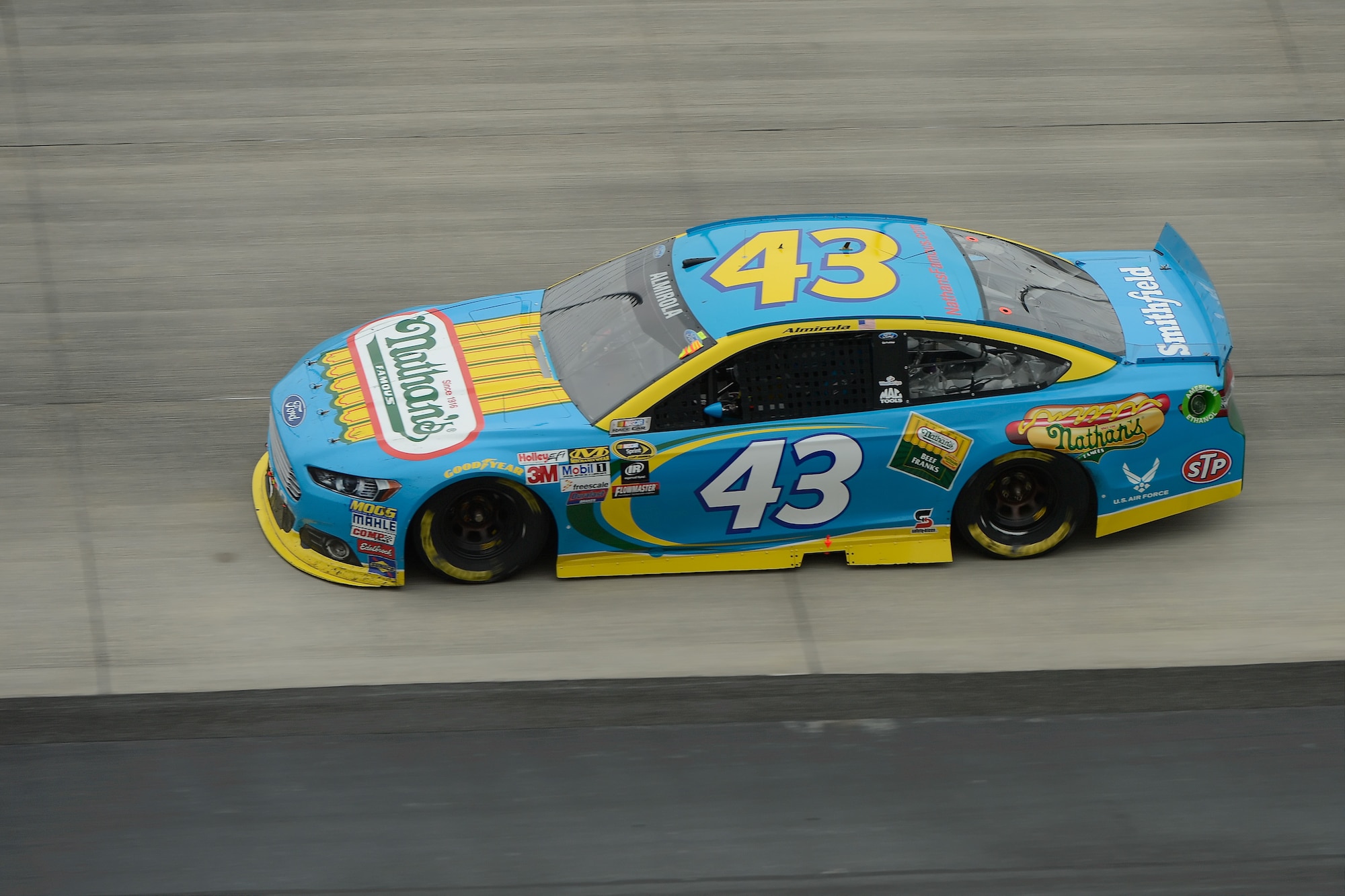 Aric Almirola races on the track of the Dover International Speedway in the Smithfield Foods Ford Fusion during the 2015 AAA 400 NASCAR Sprint Cup Series race on Oct. 4, 2015. Secretary of the Air Force Deborah Lee James joined the #43 pit crew along pit road after she opened the race as the official pace car driver during her visit. (U.S. Air Force photo/Greg L. Davis) 