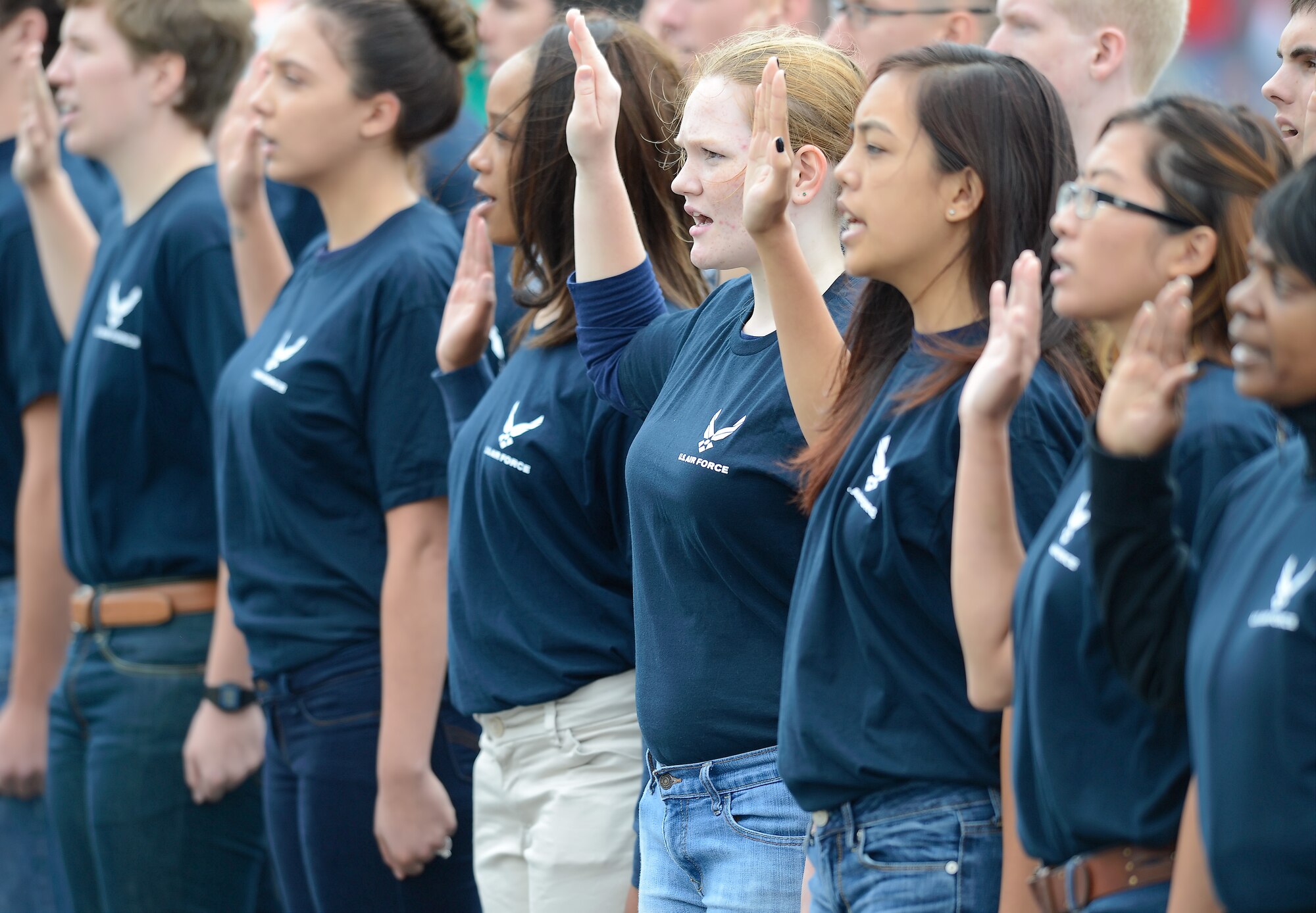 Recruits of the Air Force and Air National Guard recite the oath of enlistment while standing on the track of Dover International Speedway prior to the start of the 2015 AAA 400 NASCAR Sprint Cup Series race Oct. 4, 2015. Secretary of the Air Force Deborah Lee James gave the oath alongside Delaware's Adjutant General, Maj. Gen. Francis D. Vavala. (U.S. Air Force photo/Greg L. Davis)
