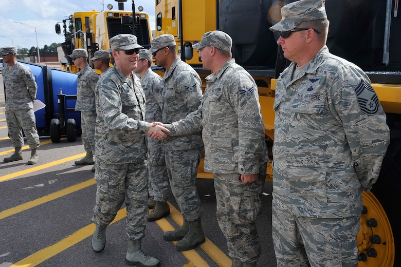 PETERSON AIR FORCE BASE, Colo. – Col. Douglas Schiess, 21st Space Wing commander, greets members of the 21st Civil Engineer Squadron during the annual “Snow Parade” down Peterson Boulevard on Sept. 29, 2015. The parade visited children at the Child Development Centers and R.P. Lee Youth Center and let them explore the machinery. The annual parade is a way to show off the CES equipment and crews who work to make Peterson roadways safe and emphasize the need to keep roadways clear and accessible for emergency vehicles. (U.S. Air Force photo by Robb Lingley)
