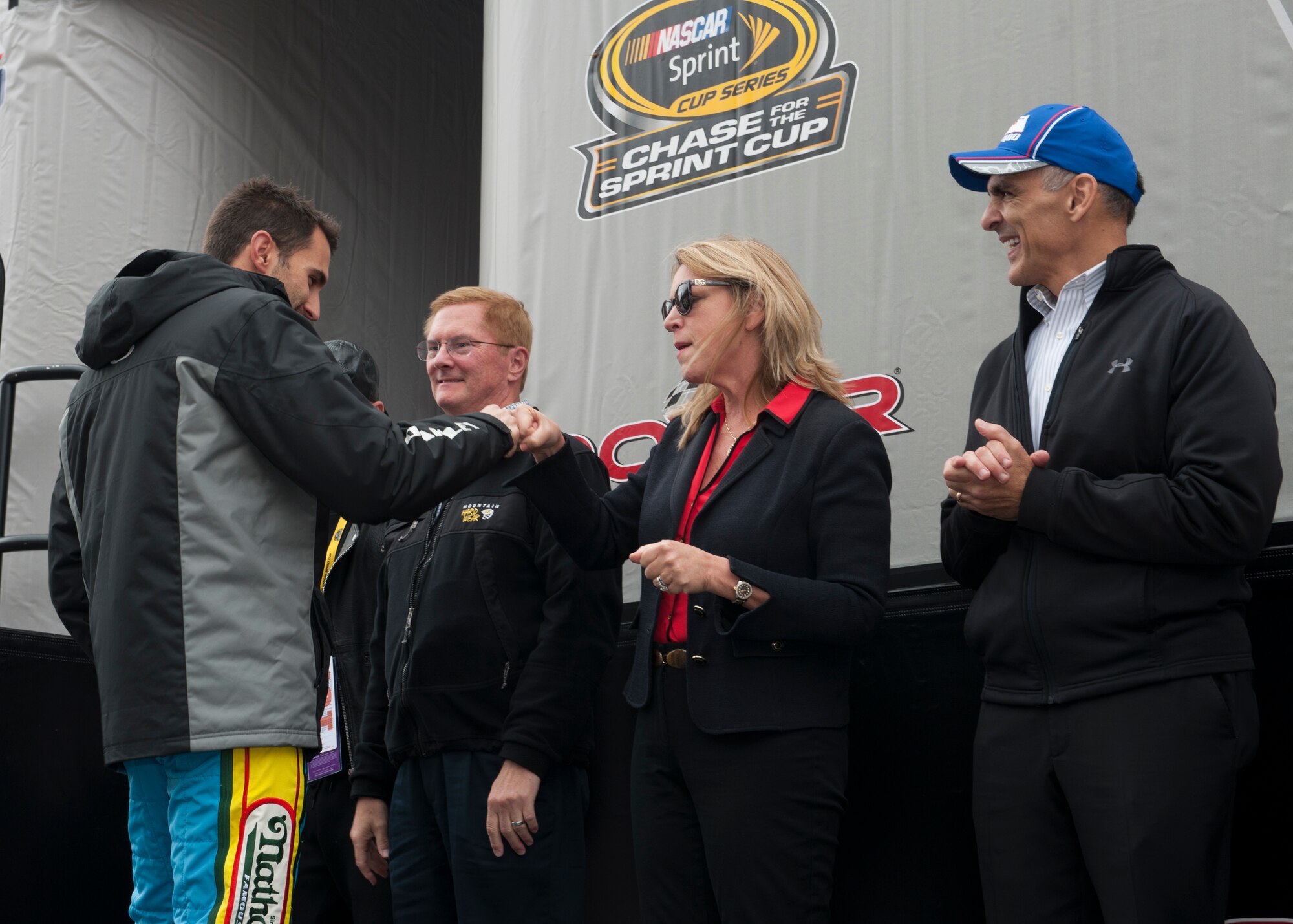 Secretary of the Air Force Deborah Lee James fist bumps Aric Almirola, driver of the #43 Ford Fusion for Richard Petty Motorsports, as he was introduced on stage prior to the start of the 2015 AAA 400 NASCAR Sprint Cup Series race Oct. 4, 2015, at Dover International Speedway in Dover, Del. The #43 car is, in part, sponsored by the U.S. Air Force. (U.S. Air Force photo/ Senior Airman Zachary Cacicia)