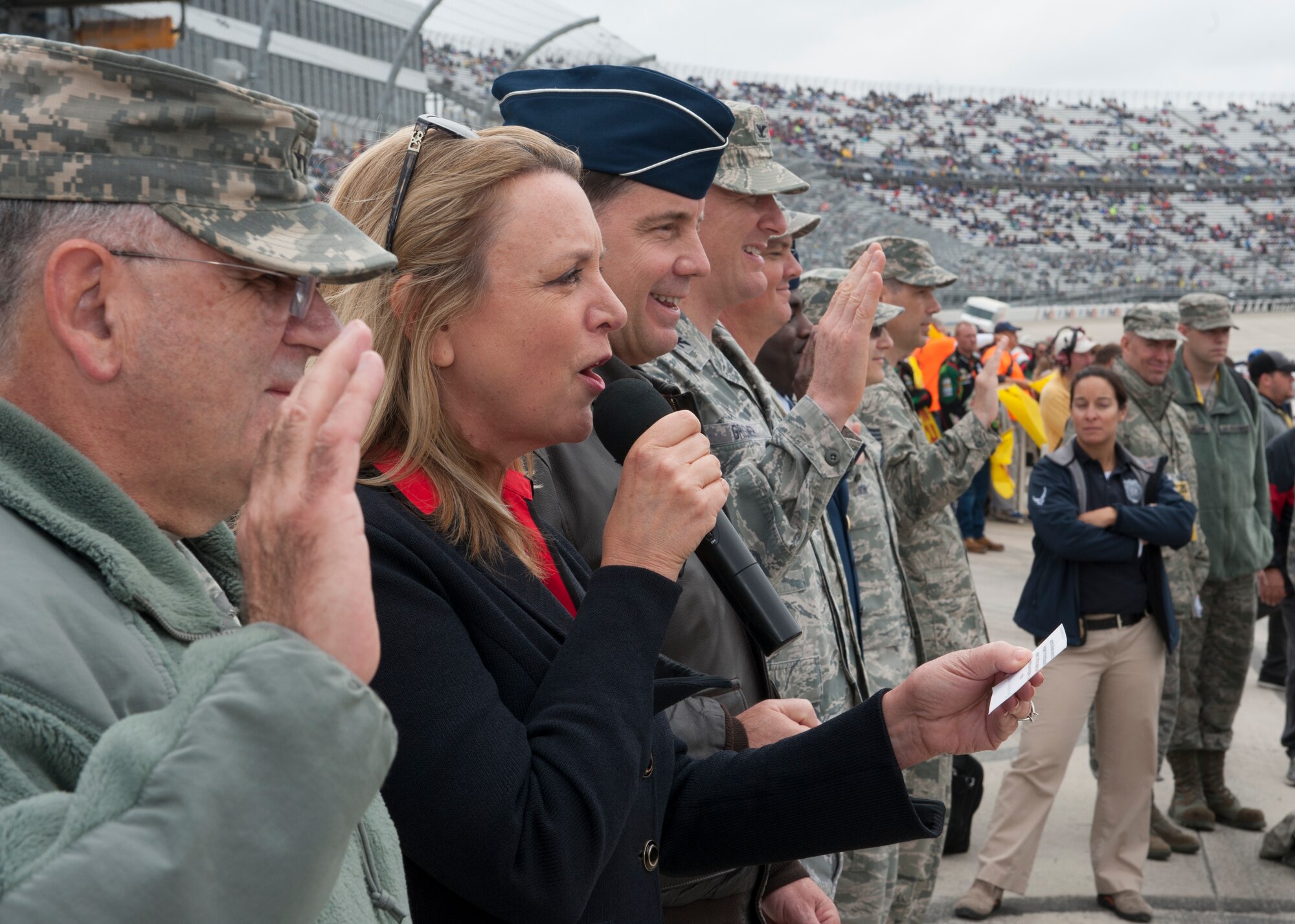 Secretary of the Air Force Deborah Lee James recites the oath of enlistment to Air Force recruits prior to the start of the 2015 AAA 400 NASCAR Sprint Cup Series race Oct. 4, 2015, at Dover International Speedway in Dover, Del. Secretary James was accompanied by Team Dover leadership as well as leadership from the Delaware National Guard. (U.S. Air Force photo/ Senior Airman Zachary Cacicia)