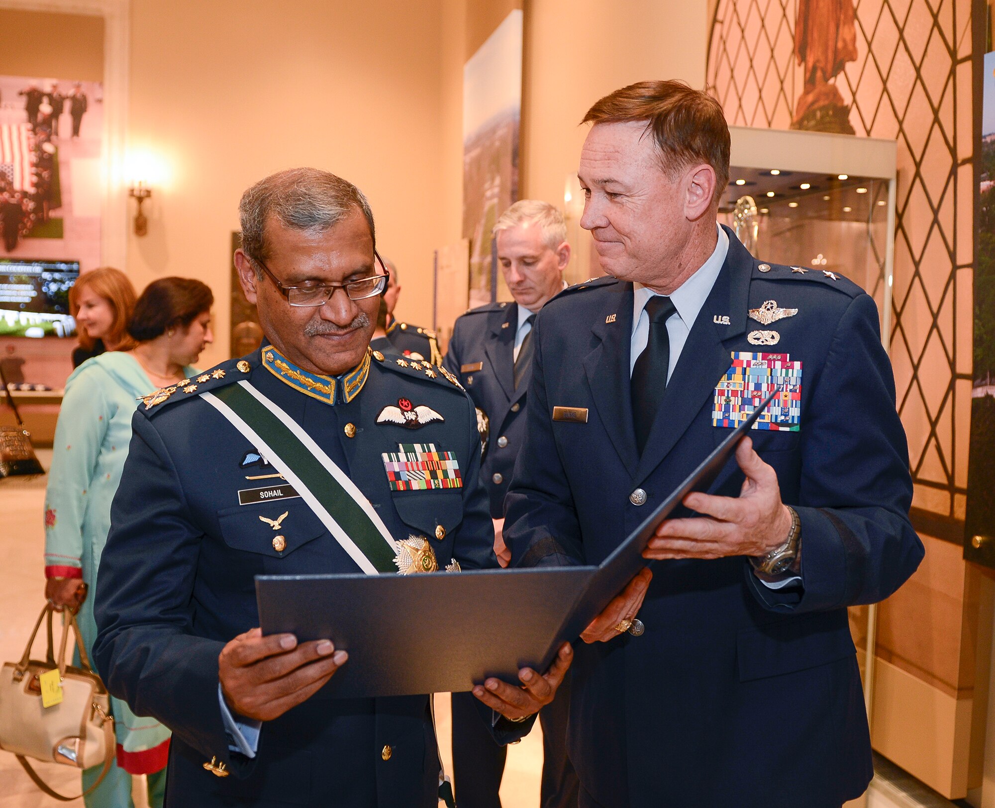 Air Chief Marshal Sohail Aman, Chief of Air Staff of the Pakistan Air Force, is presented a memento by Air Force District of Washington Commander Maj. Gen. Darryl Burke while visiting the Tomb of the Unknown Soldier for a wreath laying ceremony at Arlington National Cemetery on Oct. 6, 2015. Distinguished visitors commonly pay formal respects to the sacrifice of America's veterans in foreign wars by placing a wreath before the Tomb. The Air Force District of Washington brings air, space and cyberspace capabilities to the joint team protecting the nation's capital, and supports local personnel and those serving worldwide. (Photo/ Andy Morataya)