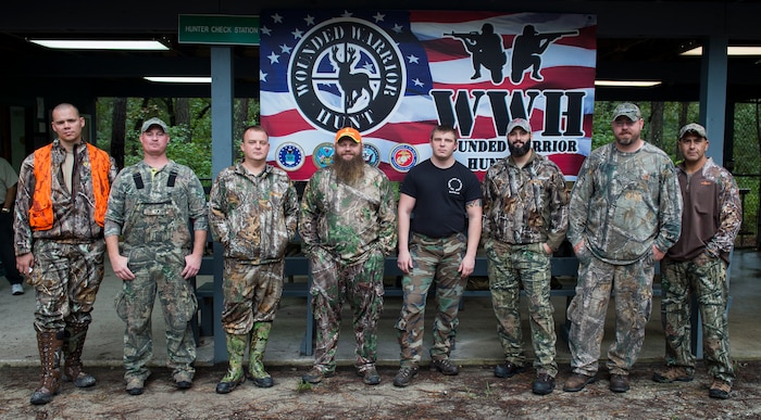 Wounded warriors participating in the 2015 Wounded Warrior Hunt gather for a group photo Oct. 2, 2015, at the hunter check station on Joint Base Charleston – Weapons Station, S.C. The Wounded Warrior project’s purpose is to provide unique, direct programs and services to meet the needs of injured service members, help injured service members aid and assist each other and raise awareness and enlist the public’s help in meeting the needs of injured service members. (U.S. Air Force photo/Airman 1st Class Clayton Cupit)