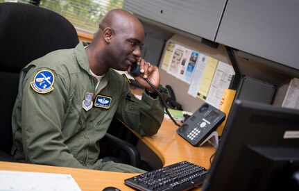 Master Sgt. Michael Seaton, 14th Airlift Squadron loadmaster superintendent, talks on the phone in his office Sept. 25, 2015, at the 14th AS on Joint Base Charleston – Air Base, S.C. Each year the Airlift/Tanker Association recognizes individuals who have demonstrated superior leadership, made outstanding contributions to the airlift/tanker mission and provided invaluable service to their civilian communities. Seaton was selected for the Air Mobility Command “Loadmaster” General Robert “Dutch” Huyser Award. (U.S. Air Force photo/Airman 1st Class Clayton Cupit) 