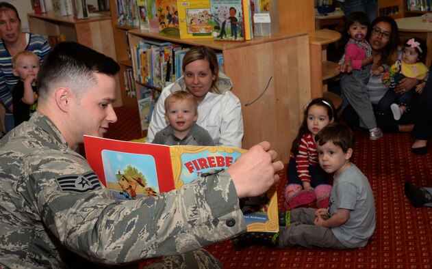 U.S. Air Force Staff Sgt. Jacob Urry, 100th Civil Engineer Squadron Fire Department firefighter, reads fire safety-themed books to families, Oct. 7, 2015, at the base library on RAF Mildenhall, England. Fire Prevention Week’s theme this year is “Hear the beep where you sleep, every bedroom needs a working smoke detector.” The week’s events include a library reading with Sparky the Fire Dog, a fire department open house, bowling with Sparky and the annual fire muster. (U.S. Air Force photo by Airman 1st Class Justine Rho/Released)  