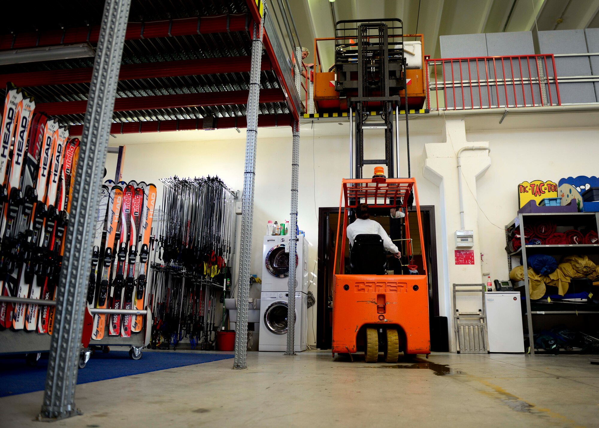 Ashley Sieber, 31st Force Support Squadron Outdoor Recreation aid, moves inventory in preparation of the winter season, Oct. 1, 2015 at Aviano Air Base, Italy. Winter gear such as snowboards and skis will be available for rent Nov. 1, 2015. (U.S. Air Force photo by Senior Airman Areca T. Bell/Released)