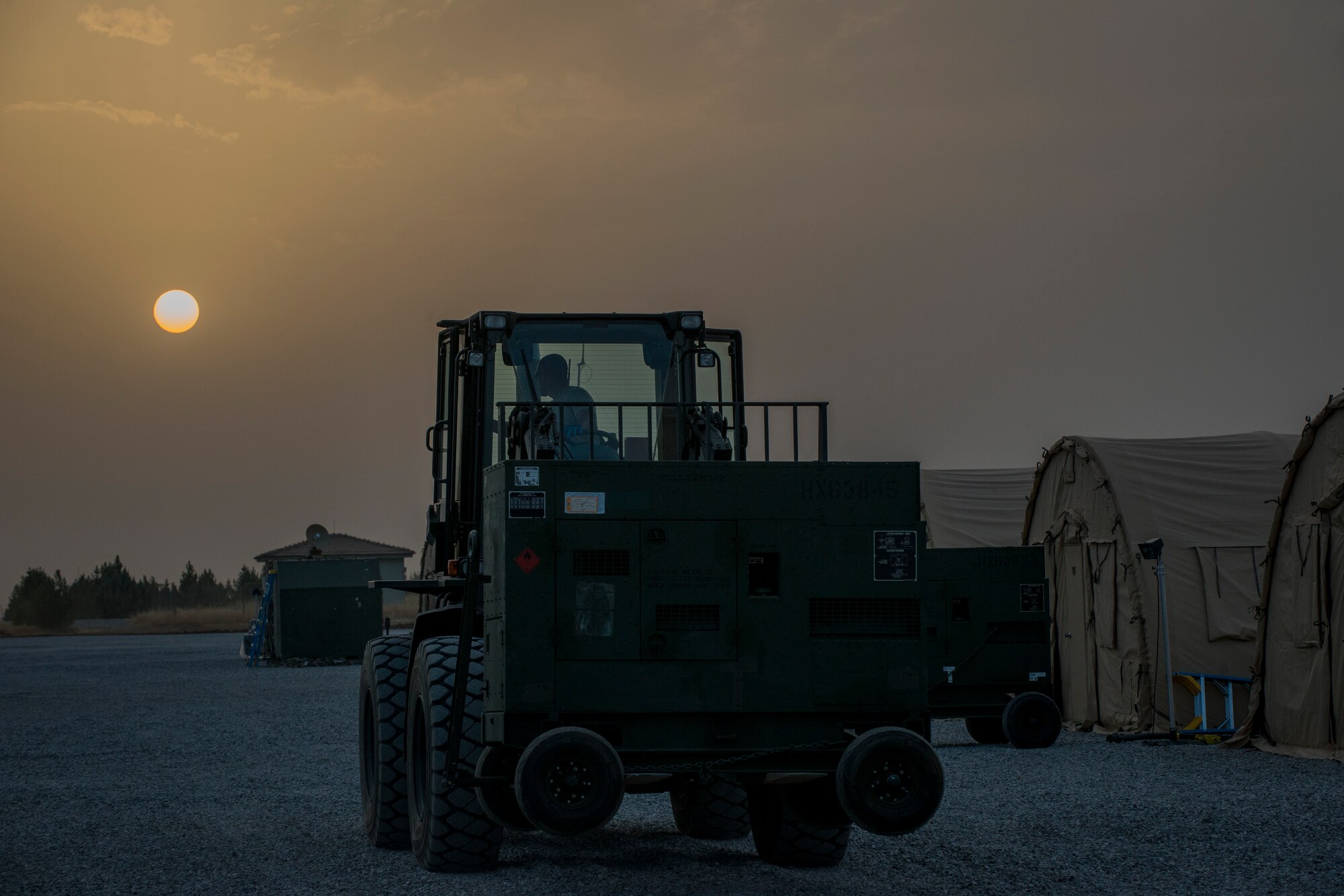Airman 1st Class Christopher McDade, 435th Contingency Response Squadron air transportation specialist, moves equipment Sept. 14, 2015, at Diyarbakir Air Base, Turkey. The 435th CRG is made up of a variety of 29 Air Force Specialty Codes and serves as U.S. Air Forces Europe and Air Forces in Africa's only expeditionary open-the-base force. The group has deployed approximately 80 Airmen to set up initial life support and operation facilities for the bed-down of personnel recovery forces standing up in Turkey. (U.S. Air Force photo by Airman Cory W. Bush/Released)