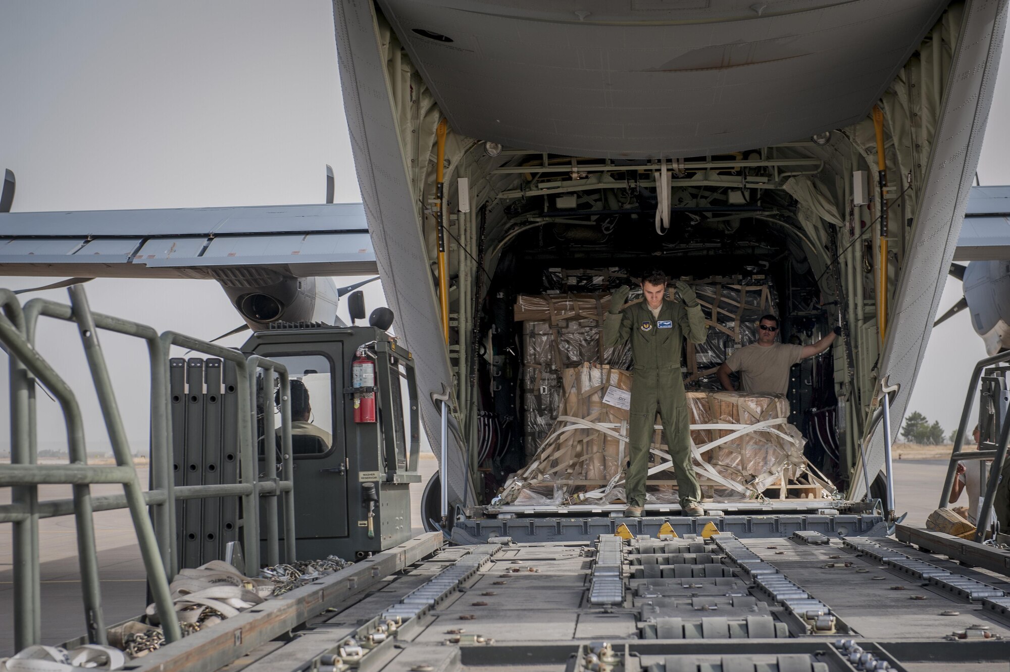 Senior Airman Dustin Dixon, 435th Contingency Response Squadron loadmaster, directs an aircraft loader during a C-130J Super Hercules off-load of equipment Sept. 12, 2015, at Diyarbakir Air Base, Turkey. Airmen from the 435th Contingency Response Group received more than 680 tons of equipment for base operations in support of the U.S. Air Force’s support personnel recovery mission from Turkey. When requested, coalition aircraft and personnel will provide recovery capability to protect and recover coalition members. (U.S. Air Force photo by Airman Cory W. Bush/Released)