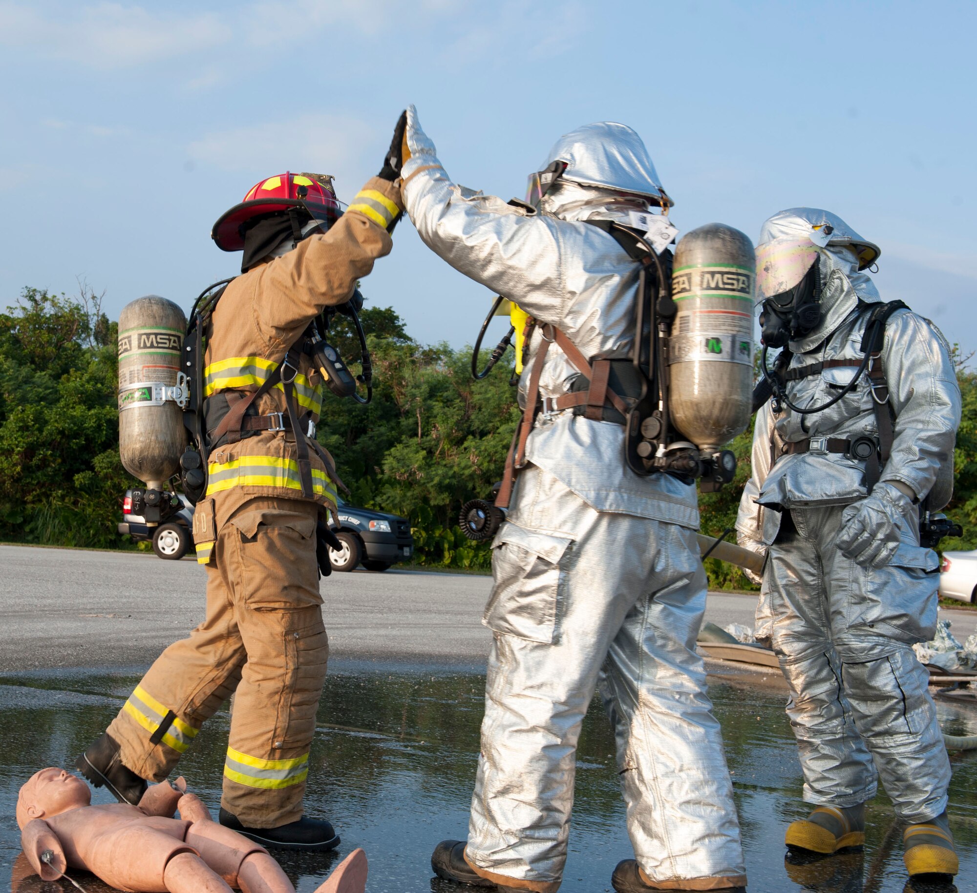 U.S. Air Force Col. Debra Lovette, 18th Mission Support Group commander, high-fives Staff Sgt. Nicholas Hayes, 18th Civil Engineer Squadron crew chief, after successfully performing rescue training during a live fire demonstration Oct. 6, 2015, on Kadena Air Base, Japan. The demonstration provided Kadena’s wing leadership with the opportunity to observe and participate in the 18th Civil Engineer Squadron’s Fire and Emergency Services Flight training. (U.S. Air Force photo by Airman 1st Class Lynette M. Rolen) 