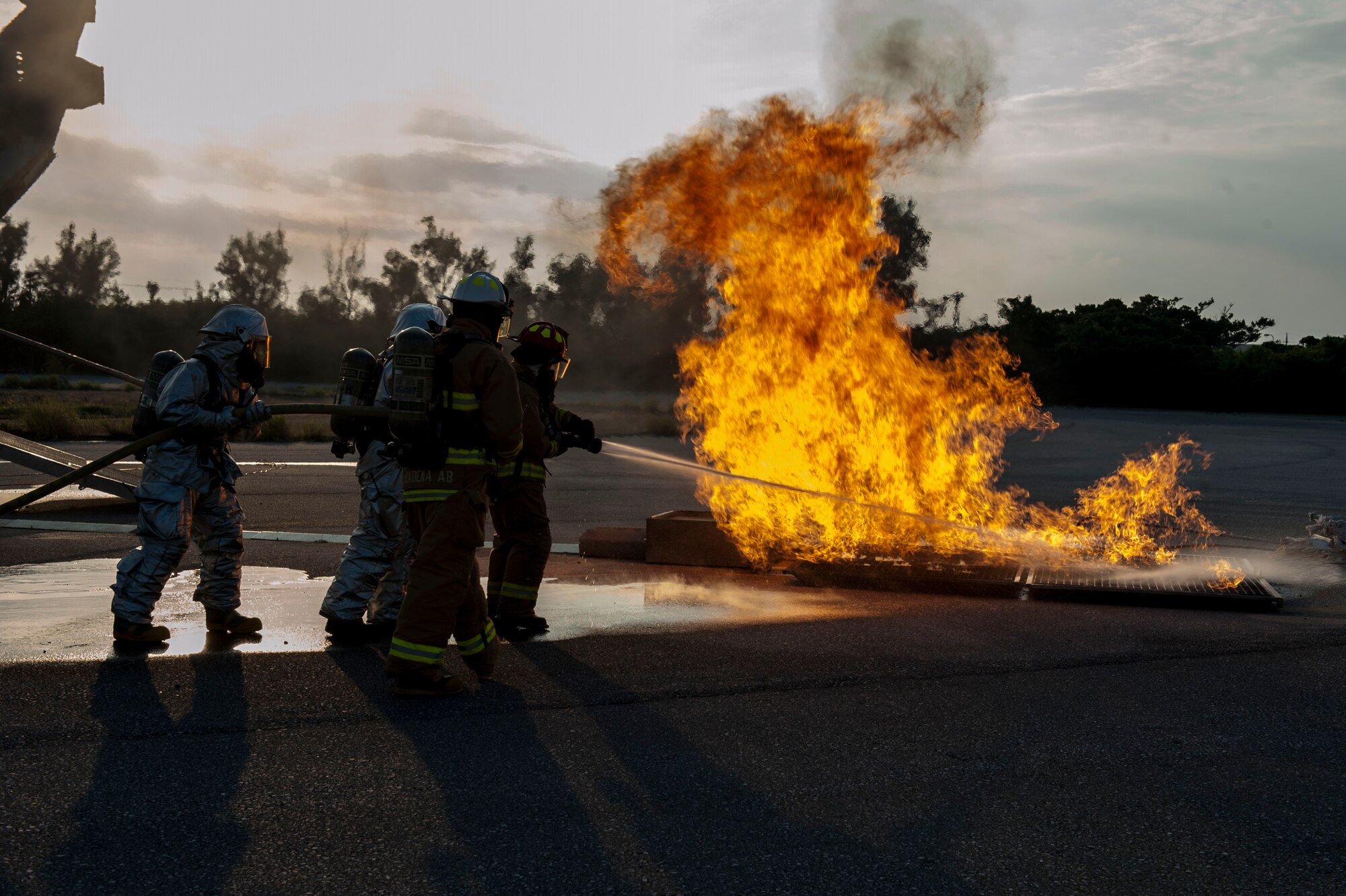 U.S. Air Force Col. Debra Lovette, 18th Mission Support Group commander, Staff Sgt. Nicholas Hayes, 18th Civil Engineer Squadron crew chief, Tech. Sgt. Matthew Peay, 18th CES safety officer, and Senior Airman Anthony Heath, 18th CES driver operator, put out a fire Oct. 6, 2015, on Kadena Air Base, Japan. The 18th Civil Engineer Squadron Fire and Emergency Services Flight hosted a live burn during a firefighting demonstration as part of Fire Prevention Week. The demonstration gave Kadena’s wing leadership the opportunity to see what the 18th CES Fire and Emergency Service Flight is prepared to do on a daily basis and how they train. (U.S. Air Force photo by Airman 1st Class Lynette M. Rolen)