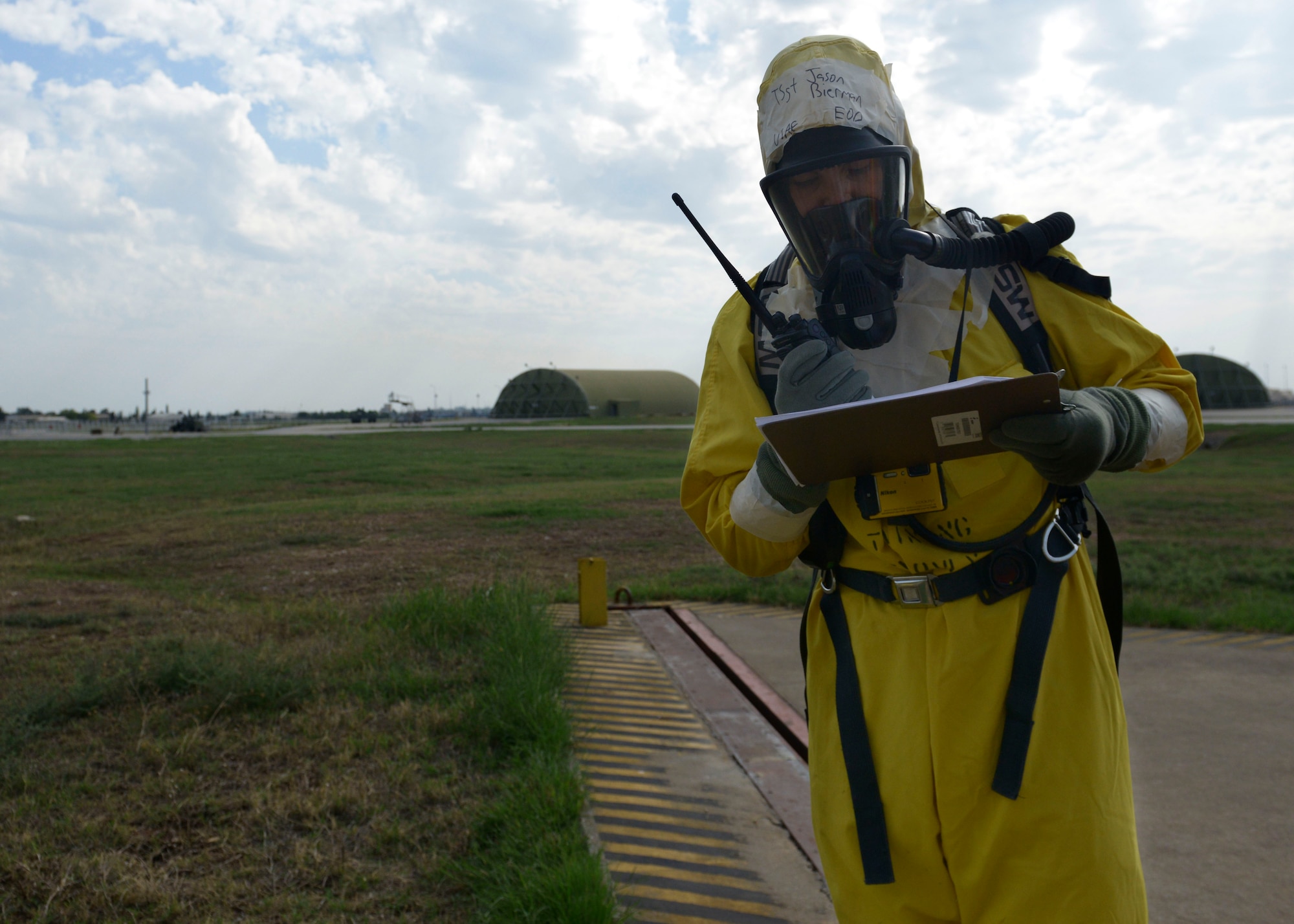 Tech. Sgt. Jason Bierman, 39th Civil Engineer Squadron explosive ordnance disposal technician, radios in radiation ratings after responding to a mock incident during a wing-wide exercise Oct. 2, 2015, at Incirlik Air Base, Turkey. The exercise tested the base's readiness and capabilities to respond to an emergency at a moment's notice. (U.S. Air Force photo by Senior Airman Krystal Ardrey/Released)