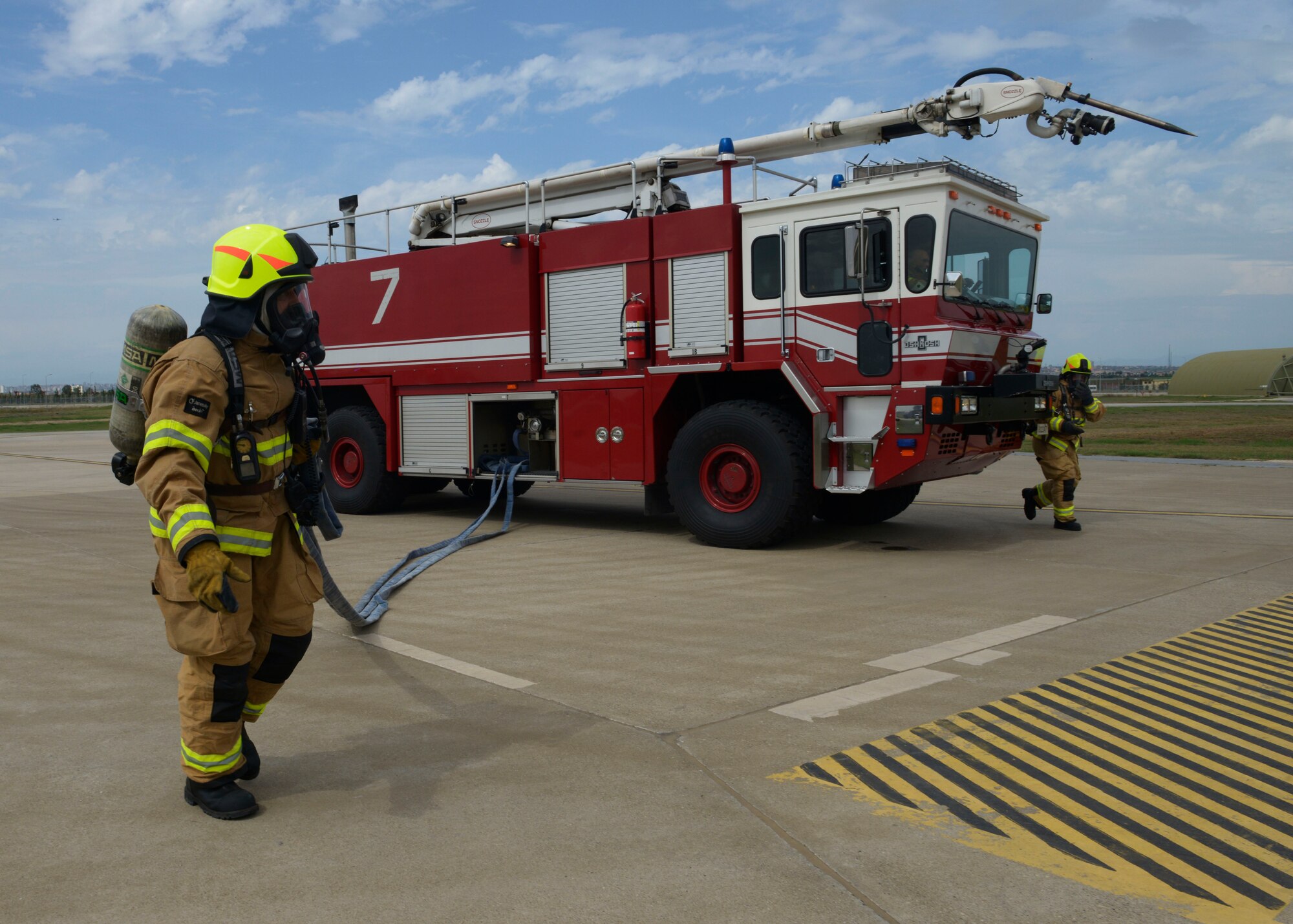 Firefighters from the 39th Civil Engineer Squadron respond to a mock fire during a wing-wide exercise Oct. 2, 2015, at Incirlik Air Base, Turkey. The firefighters participated in the exercise to test their response time for flight line emergencies and procedures for suppressing a fire inside of a protective aircraft shelter. (U.S. Air Force photo by Senior Airman Krystal Ardrey/Released)